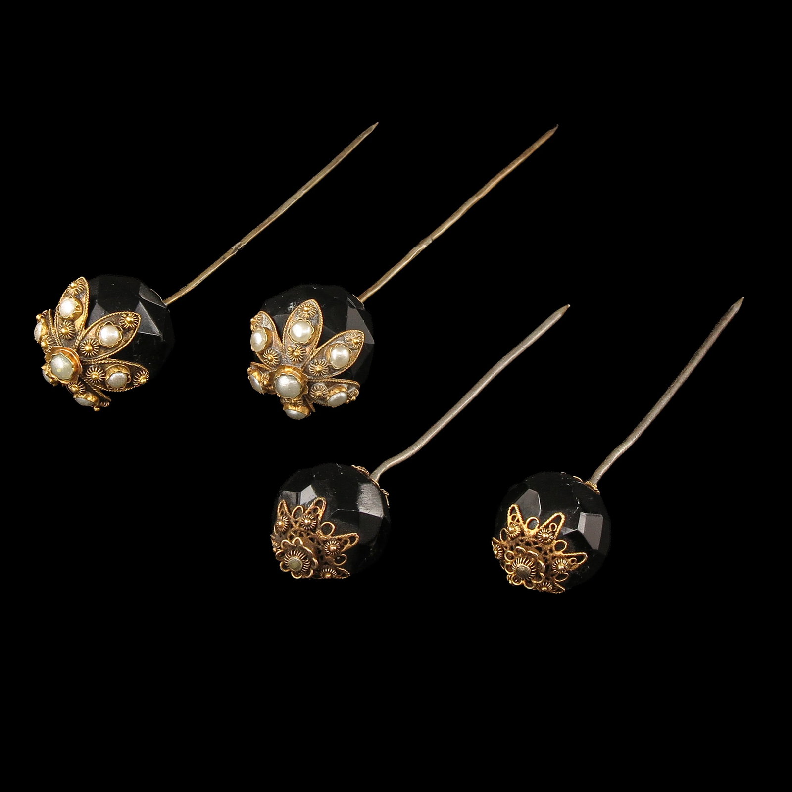A Group of Mourning Pins: consisting of 2 pairs of mourning pins, set with garnet and seed pearls, length 8 cm.