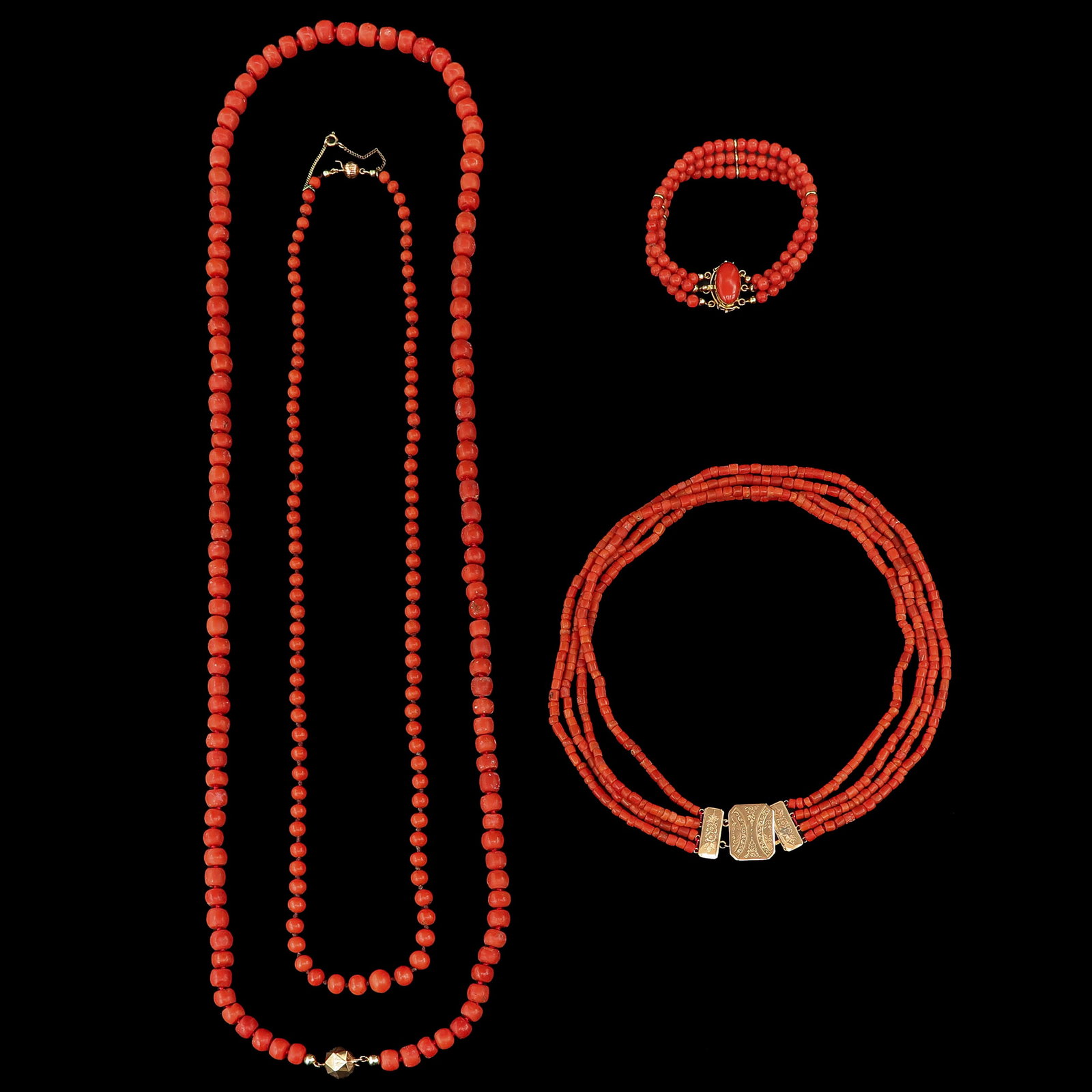 A Group of Necklaces: consisting of 3 necklaces and a bracelet, including red coral and gold, longest 94 cm.