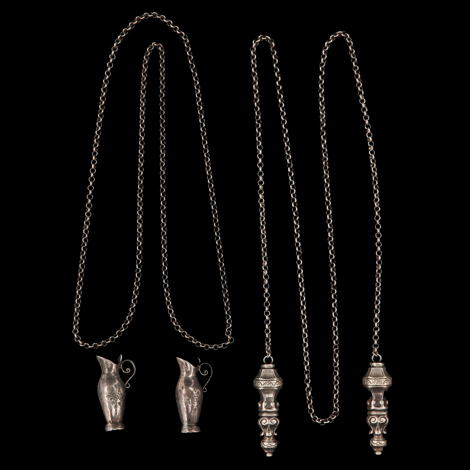 A Lot of Silver Knitting Needle Caps: consisting of 2 pairs of silver knitting needle caps on long silver chains, including pair in the form of small jugs, longest 97 cm.