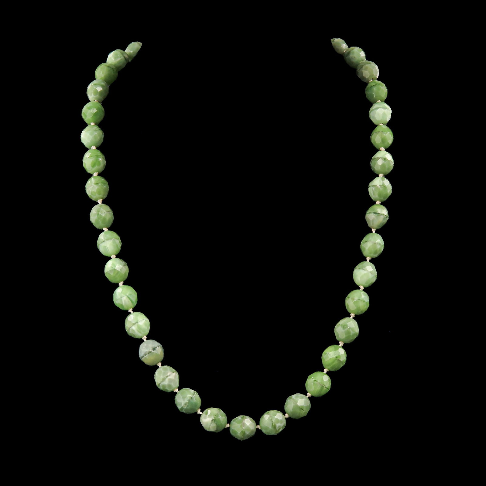 A Necklace: with faceted green beads and gold clasp, length 52 cm.
