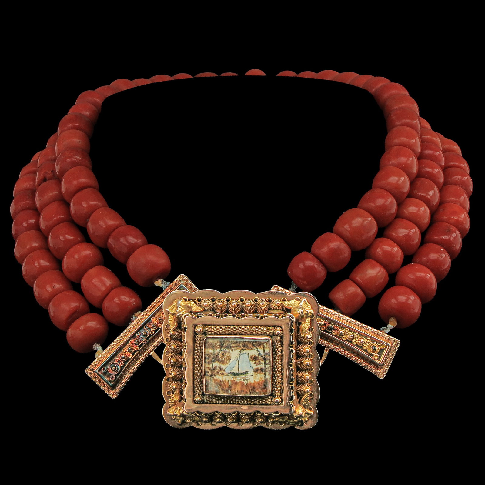A Red Coral Necklace: 3 rows red coral, with 14 Krt gold Volendam clasp, diameter beads 10 - 12 mm., weight 200 grams