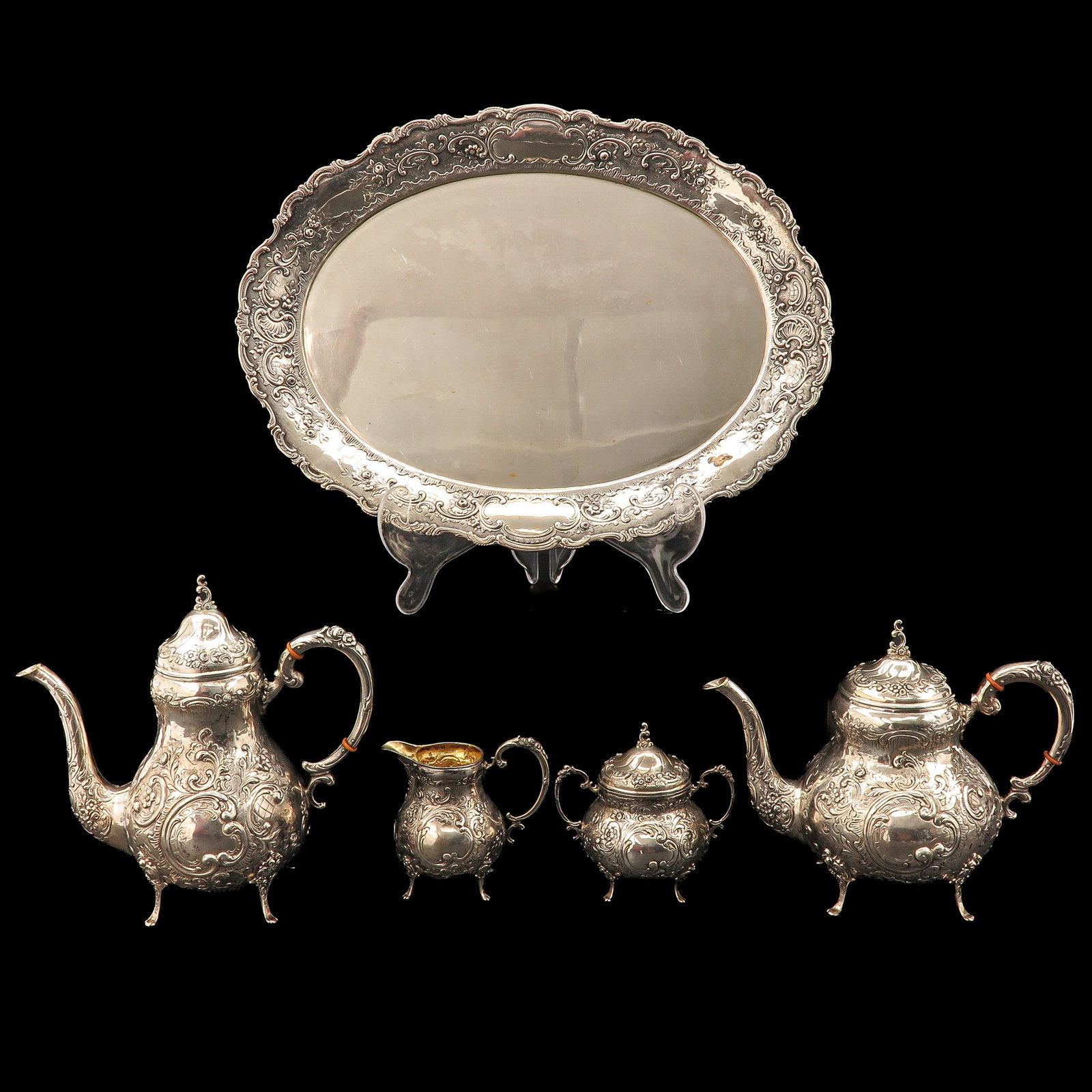 A Tea and Coffee Service: tea and coffee, consisting of a tray, coffee pot, teapot, milk jug and sugar bowl, richly decorated with ornaments, 800/1000 silver, tray 45 x 34 cm.