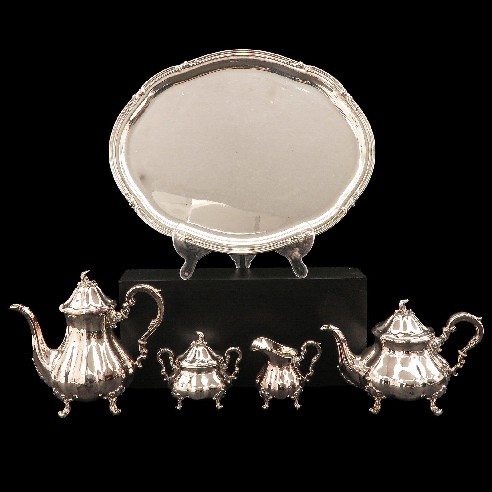 A Tea and Coffee Service: Sterling, designed for Spritzer & Fuhrmann, consisting of a coffee pot, teapot, sugar bowl with lid, milk jug and oval tray, length tray 49 cm.