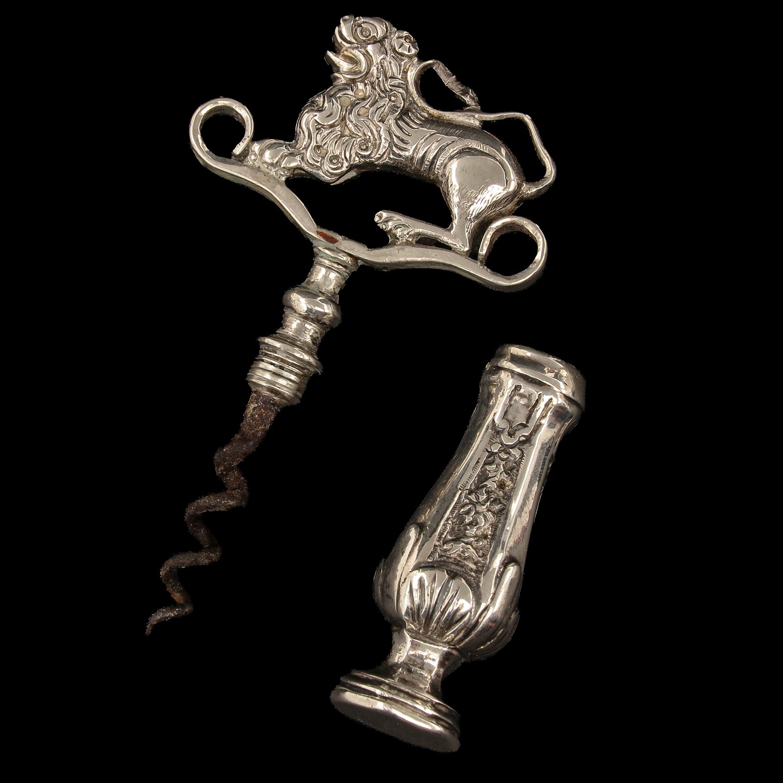 A Silver Corkscrew: silver, Schoonhoven, 18th century, provided with handle surmounted by a lion, see marks, length 9 cm.