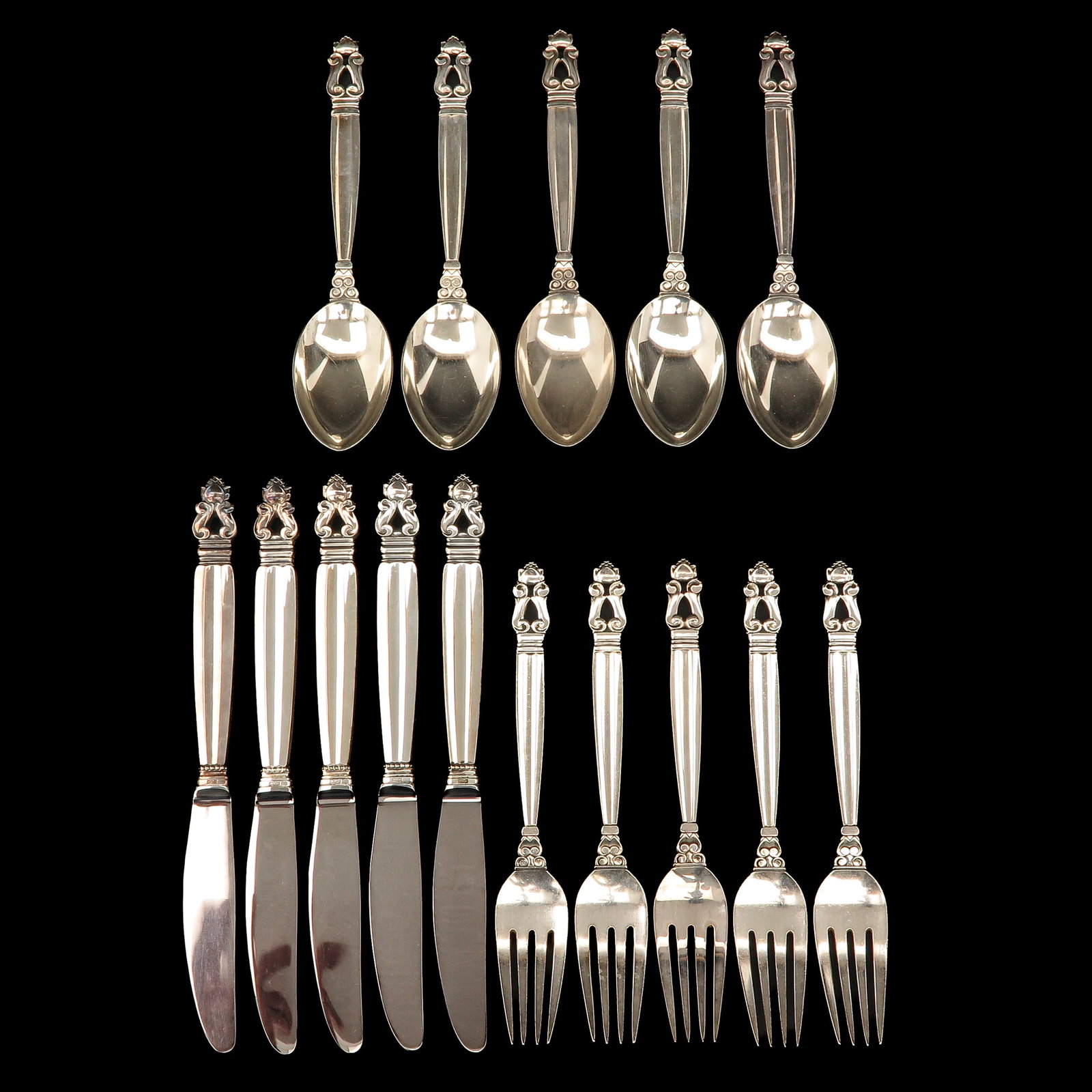 A Group of Georg Jensen Cutlery: consisting of 5 dinner knives, 5 dinner forks and 5 dinner spoons, Georg Jensen, model Acorn, designed by Johan Rohde, longest 23 cm.