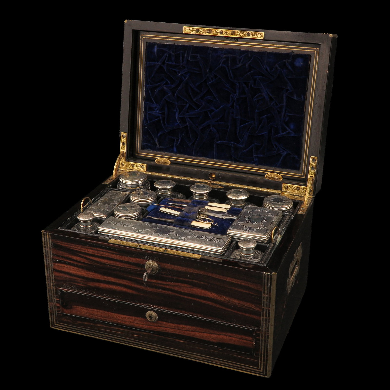 A Travel Chest: rosewood, with interior, provided with crystal flacons with silver mounts, 33 x 24 x 24 cm.