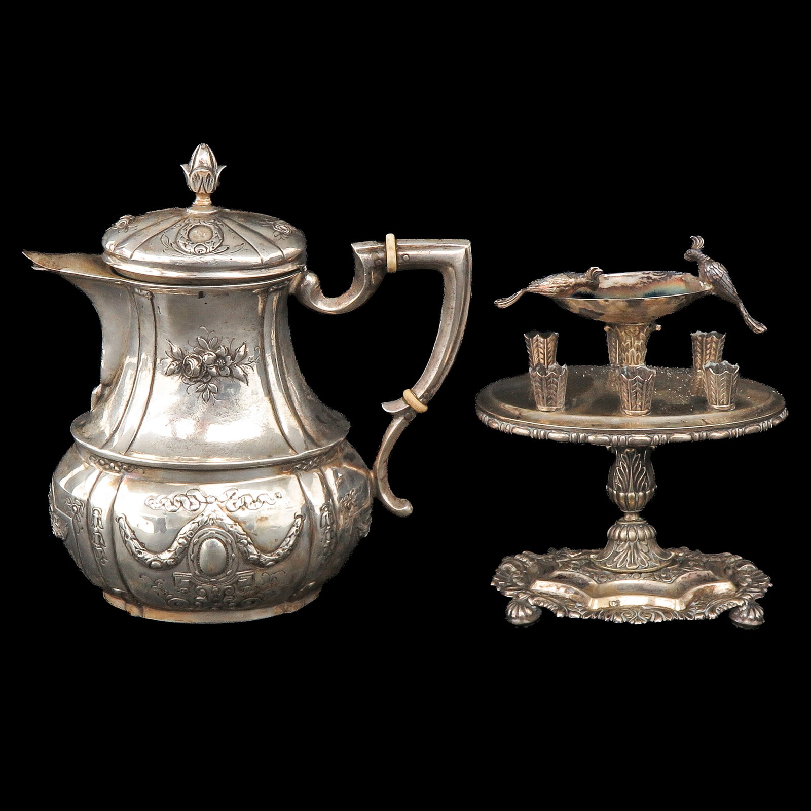 A Table Piece and Teapot: consisting of a table piece and a teapot, including 800/1000 silver, tallest 16 cm.