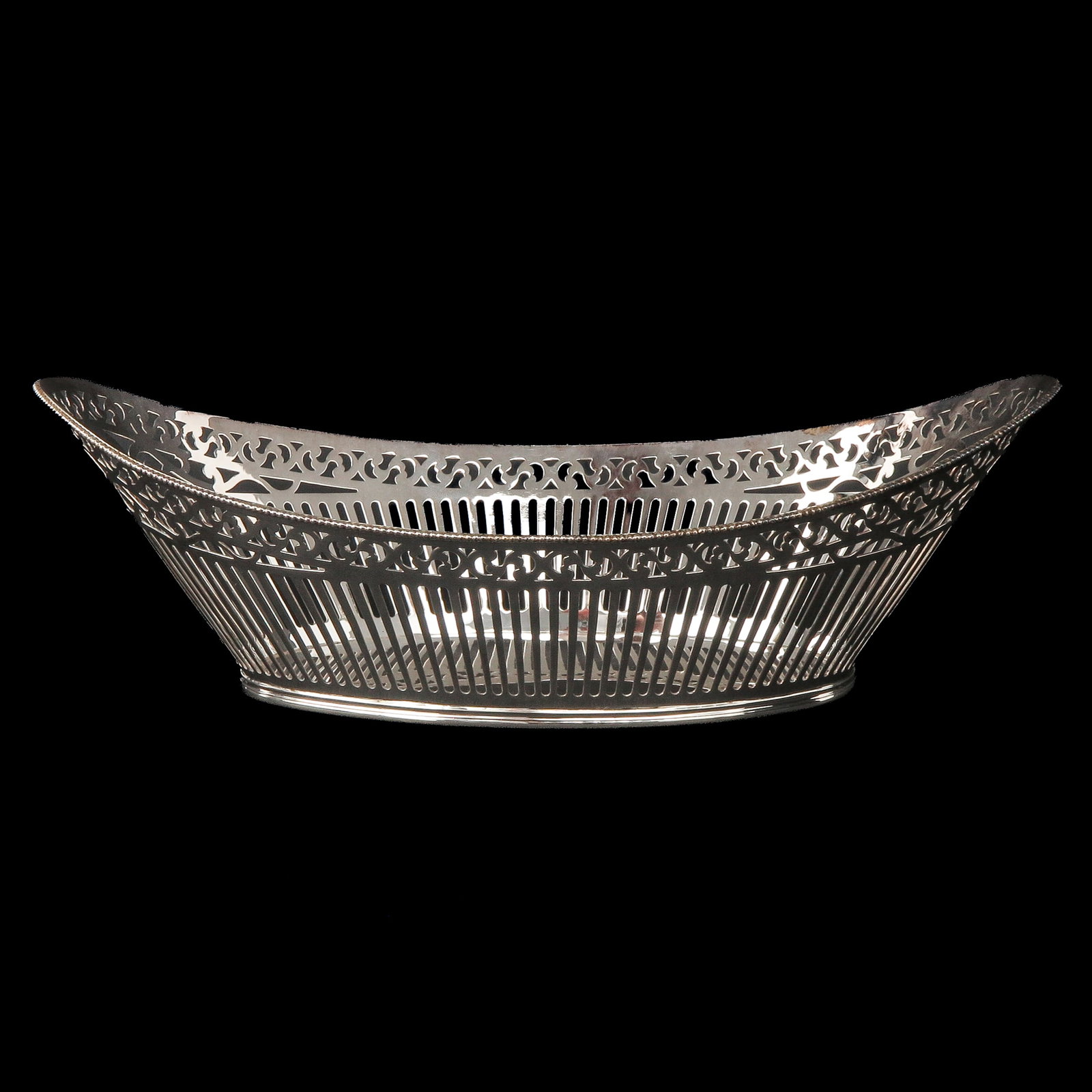 A Silver Bread Basket: silver, boat-shaped with sawn decoration, length 30 cm.