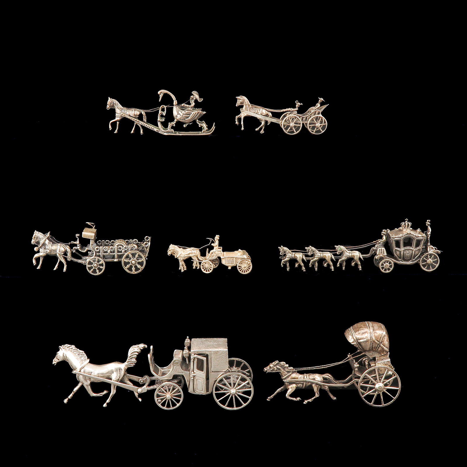 A Group of Miniatures: consisting of 7 silver miniatures, including coachman and horses, longest 16 cm.