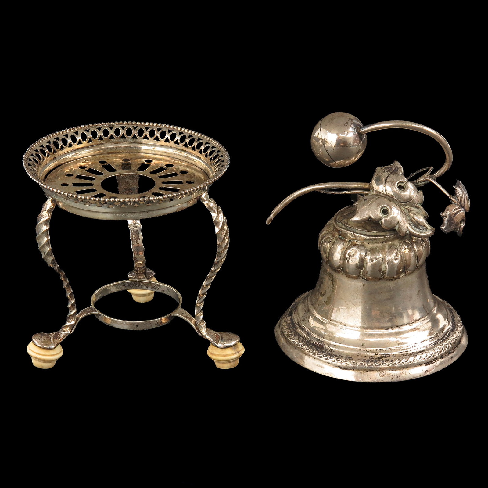 A Table Bell and Tea Light: consisting of a silver table bell and tea light, tallest 12 cm.