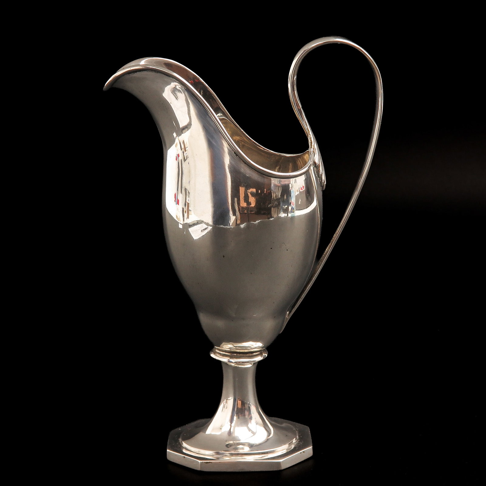 A Ewer: Vienna, ca. 1818, 800/1000 silver, provided with an elegantly arched handle that terminates in a characteristic fan- or shell motif on the body, height 23 cm.