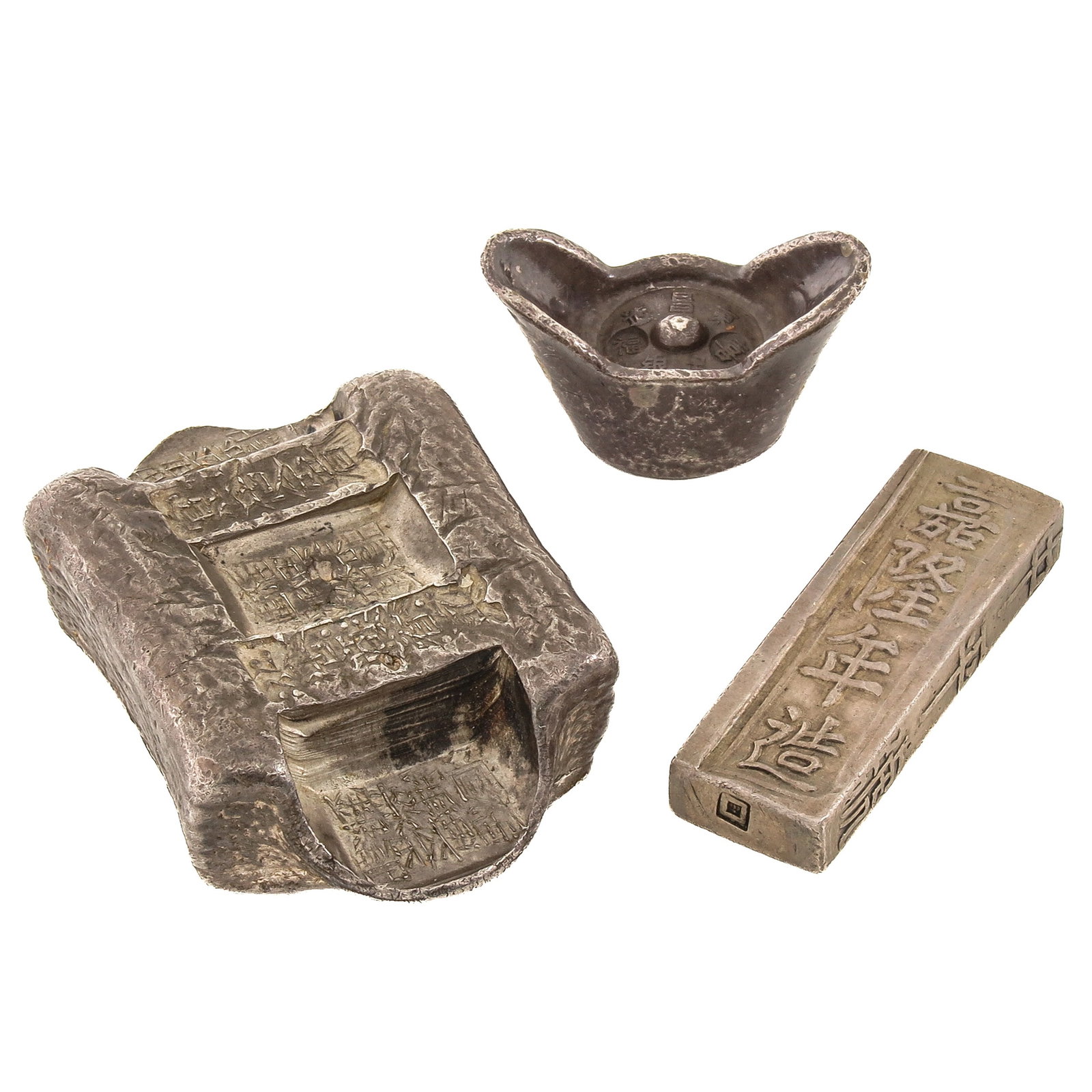 A Group of 3 Chinese Silver Monetary Objects: Silver sycees, largest is 35 x 55 x 16 mm.