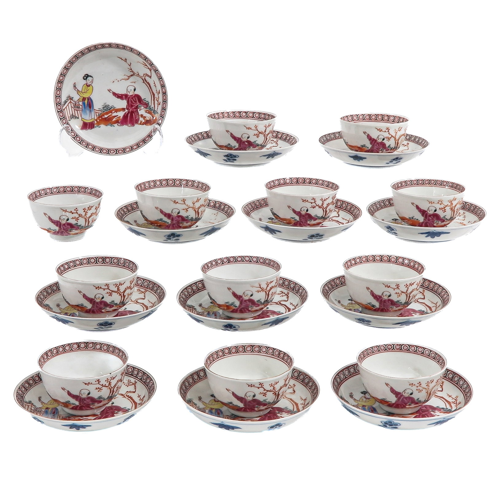 A Set of 12 Cups and Saucers: Decorated in Famille Rose palette with figures in a landscape and a geometric border, Kangxi mark, saucers are 12 cm. in diameter.