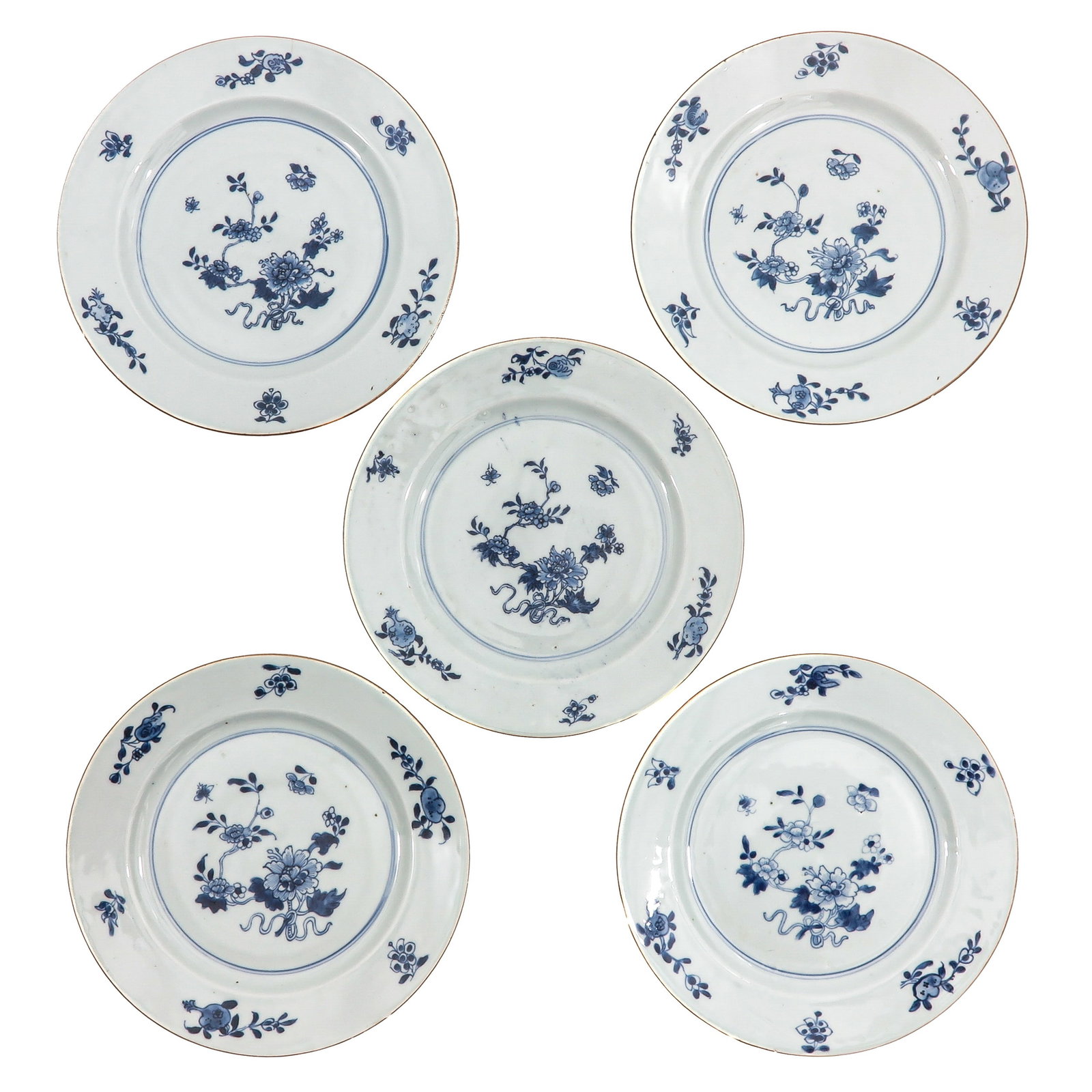 A Series of 5 Blue and White Plates: Decorated with floral sprays and scattered blossoms, 18th Century, 23 cm. in diameter, chip and hairline.