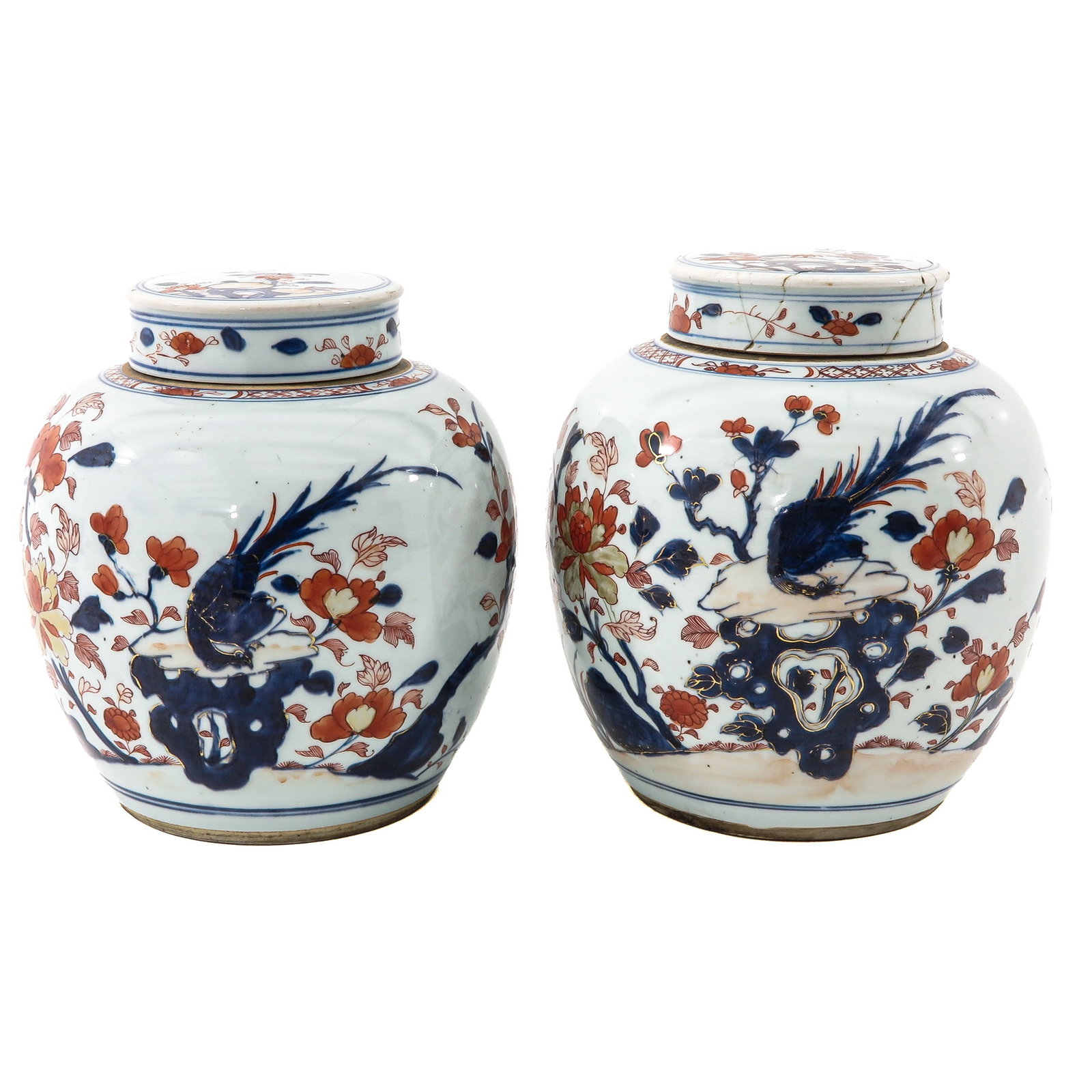 A Pair of Imari Ginger Jars: Decorated with a bird among flowering branches and peonies, 24 cm. tall, 18th Century, restored cover.