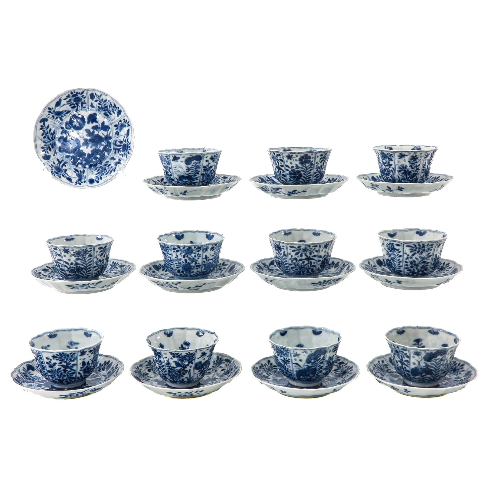 A Group of Cups and Saucers: Including 12 saucers and 11 cups, decorated with floral motifs, 18th Century, saucers are 13 cm. in diameter, chip and hairline.