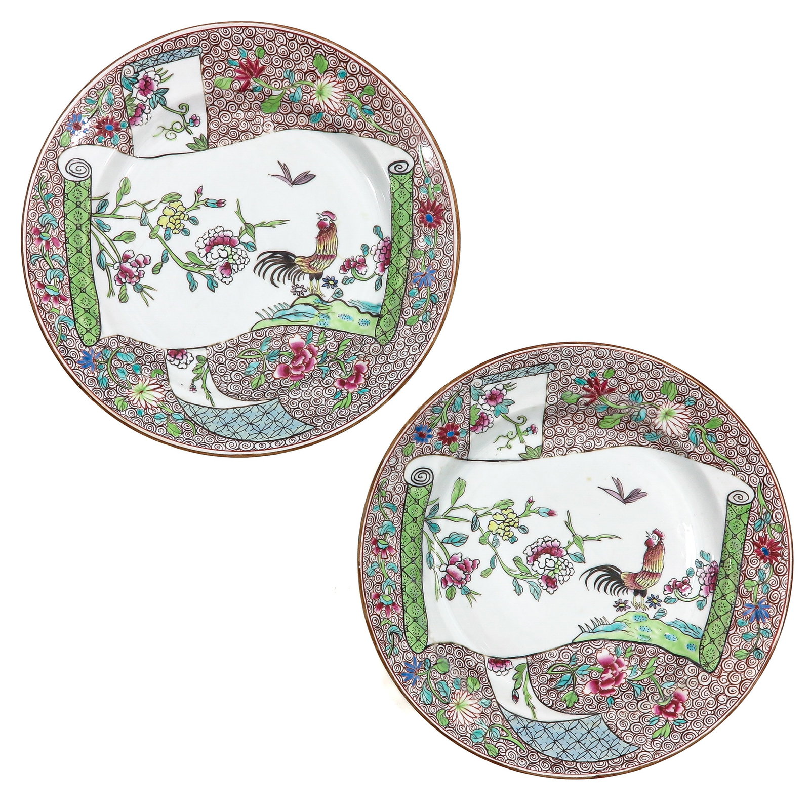 A Pair of Famille Rose Plates: Decorated with a rooster amid flowering branches and scroll motifs, 23 cm. in diameter, hairline.