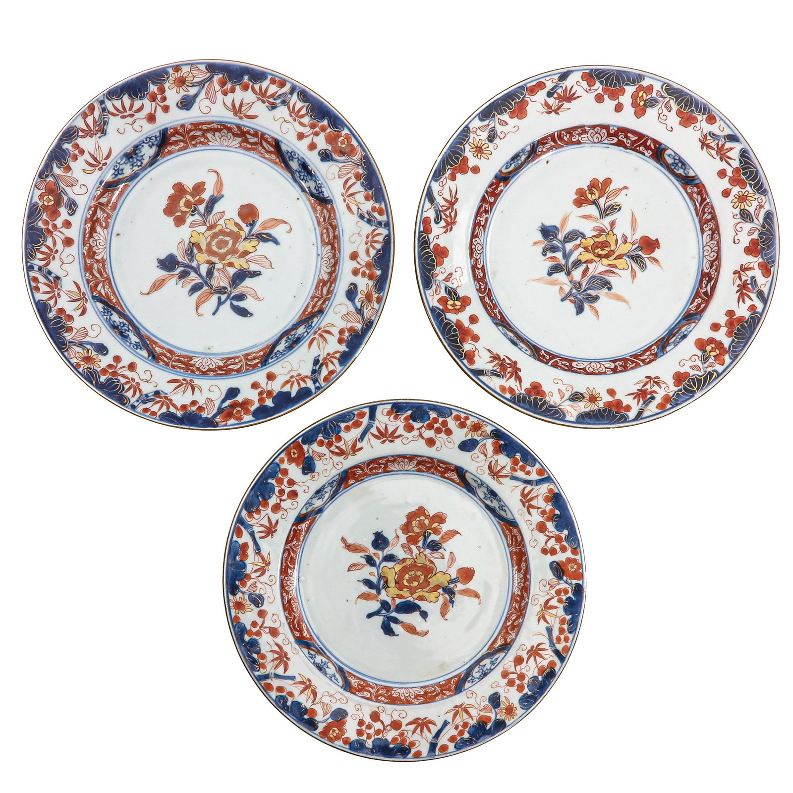 A Series of 3 Imari Plates: Decorated with floral motifs in underglaze blue, iron red and gilt highlights, 18th Century, 24 cm. in diameter, chip.
