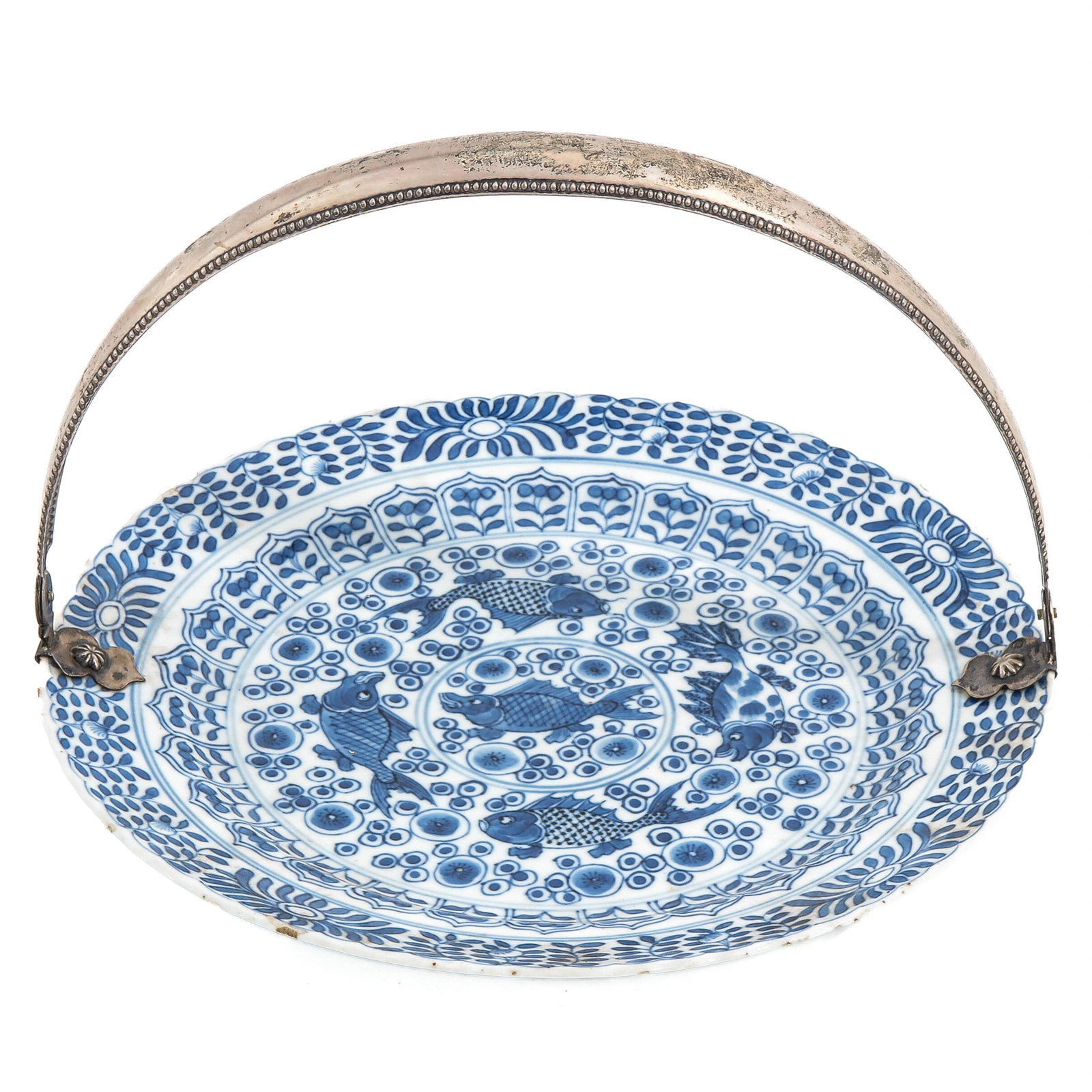 A Blue and White Serving Plate with Silver Handle: Decorated with carp swimming among stylized blossoms and floral borders, 18th Century, 24 cm. in diameter, chip and hairline.