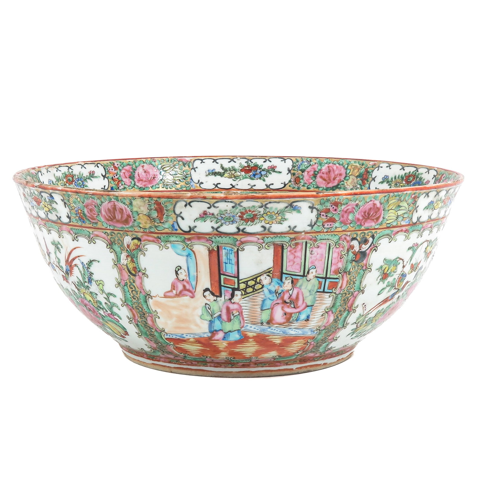 A Cantonese Serving Bowl: Decorated with panels depicting figures in an interior, reserved against a floral ground in Famille Rose enamels, 41 cm. in diameter, fritting.