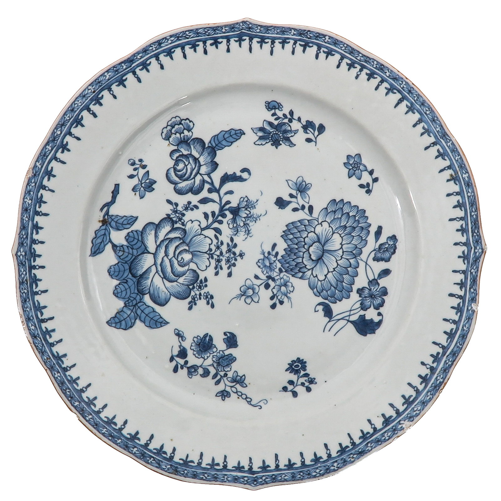 A Blue and White Plate: Decorated with various flowering plants within a floral border, 18th Century, chip.