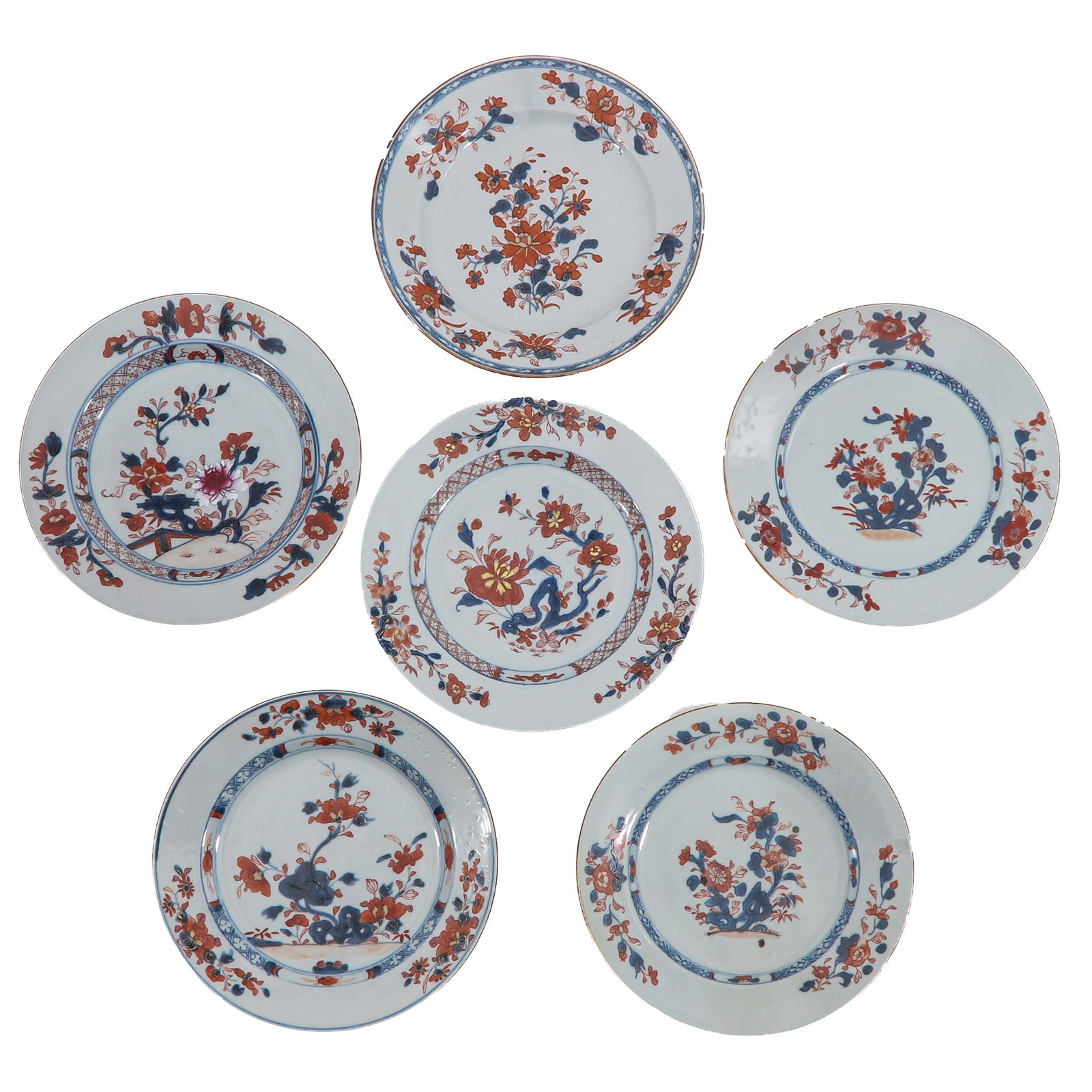 A Group of 6 Imari Plates: Decorated with flowering plants in underglaze blue, iron red and gilt, 18th Century, 23 cm. in diameter, chip and hairline.