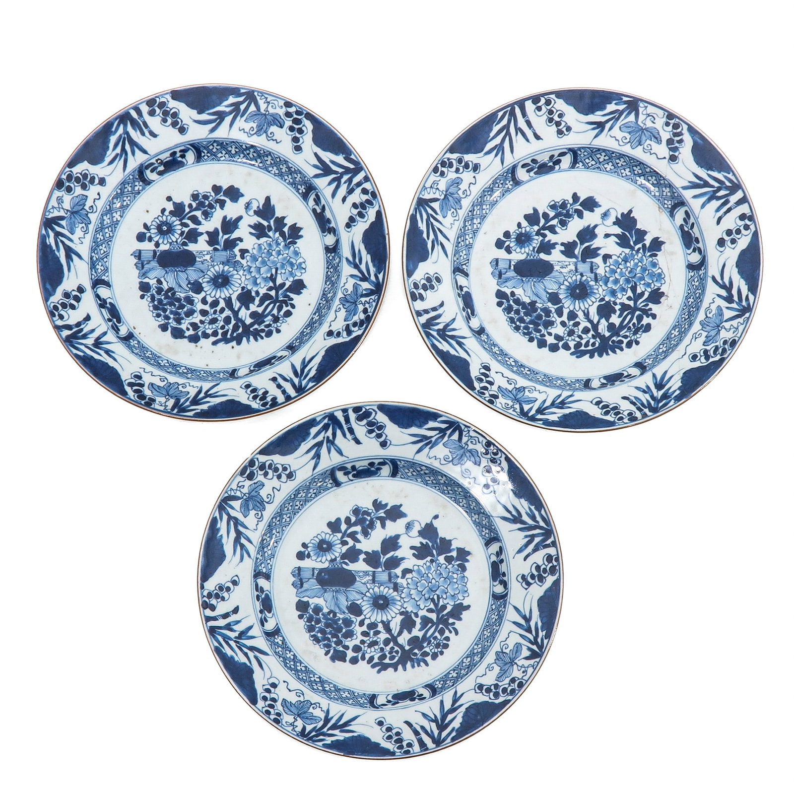 A Series of 3 Blue and White Plates: Decorated with flowering plants, a garden bridge and a butterlfy within a floral border, 28 cm. in diameter, in diverse conditions