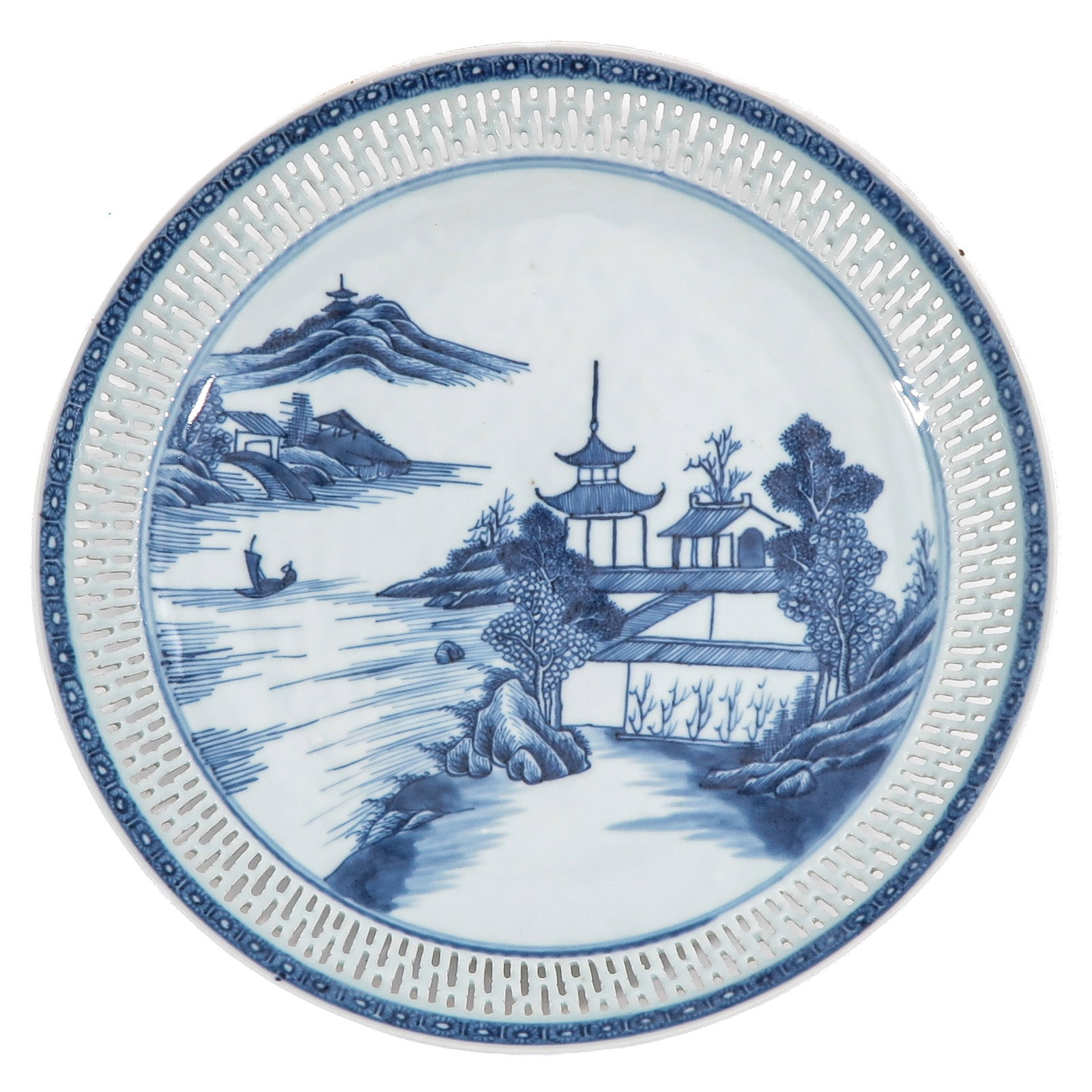 A Blue and White Reticulated Dish: Qianlong Period, decorated with river landscape and pavilions, 28 cm. in diameter, chip and hairline.