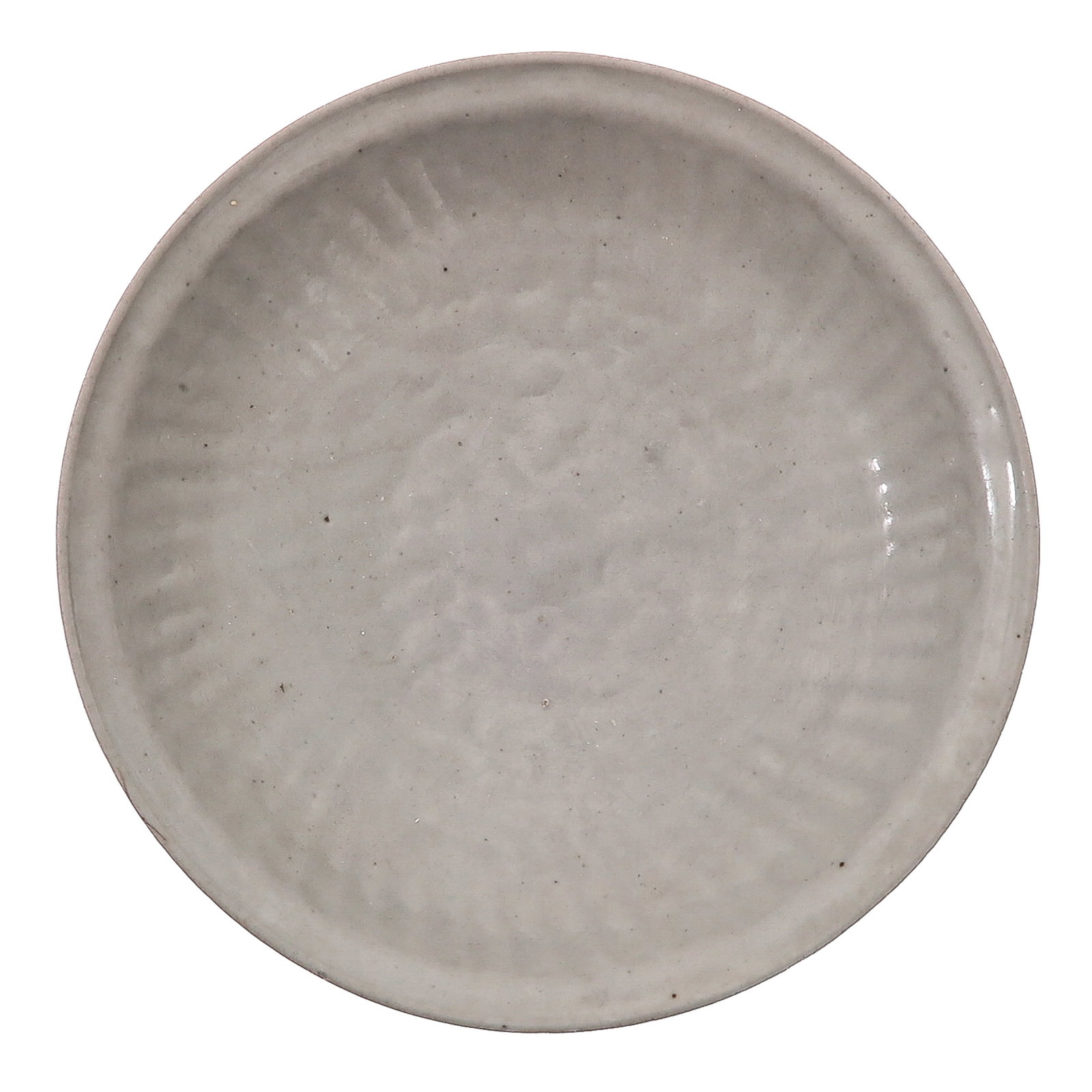 A White Glazed Porcelain Dish: With molded floral decoration, Ming dynasty, 21 cm. in diameter.