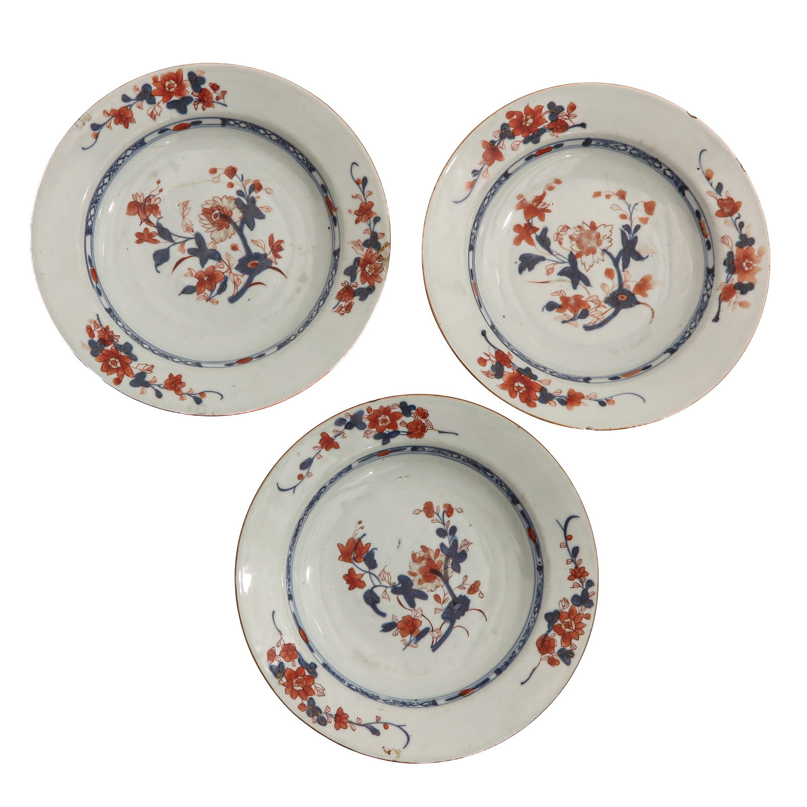 A Series of 3 Imari Plates: Decorated with floral sprays in underglaze blue and iron-red, 18th Century, 22 cm. in diameter, chip and hairline.