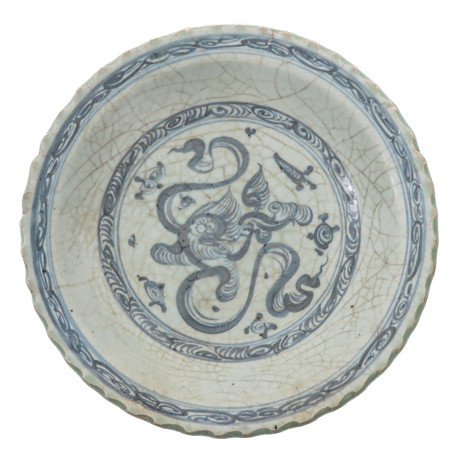 A Blue and White Dish: Central motif hand painted in underglaze blue with a phoenix and auspicious emblems, with scalloped rim, Ming dynasty, Longqing Period, 25 cm. in diameter, hairline.