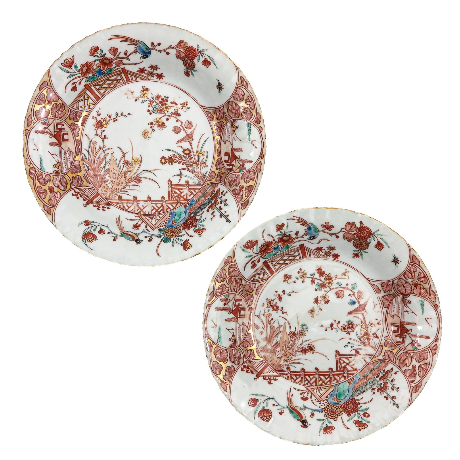 A Pair of Amsterdams Bont Decor Plates: 18th Century, decorated with a fenced garden, flowering branches, birds and ornamental reserves, 22 cm. in diameter, chip.