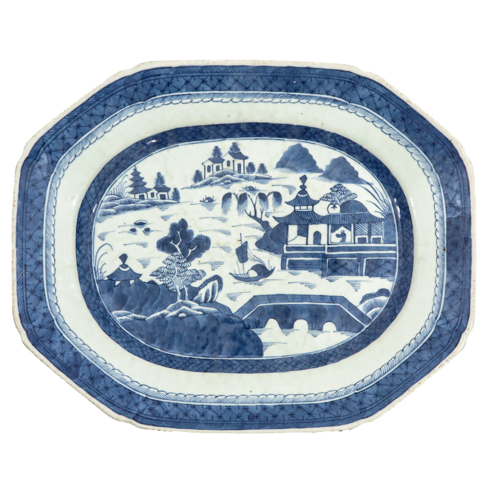 A Blue and White Serving Plate: Landscape decor with pagodas and sail boat, circa 1800, 39 cm. long.