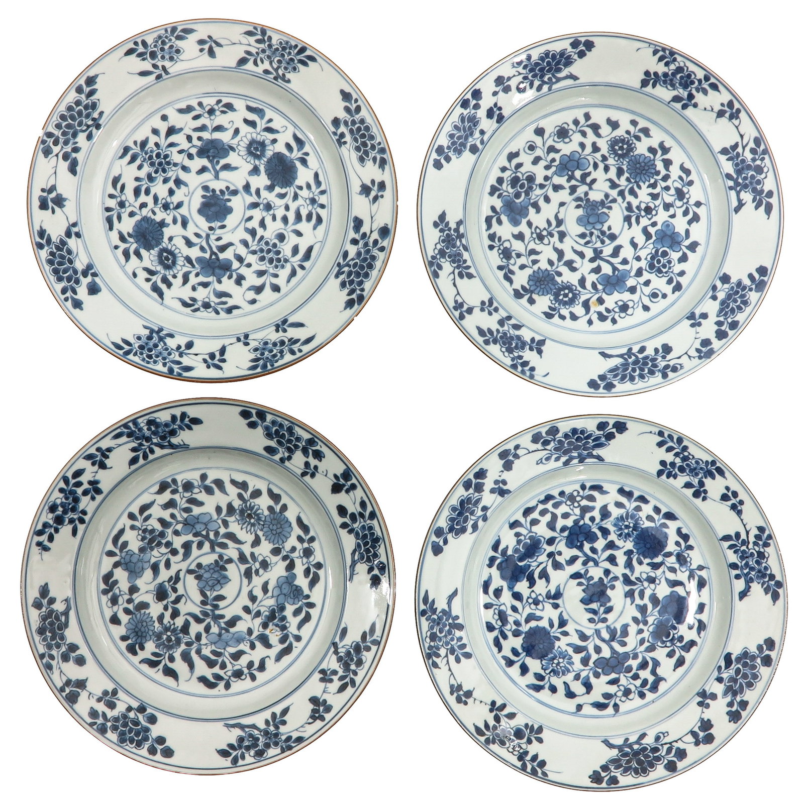 A Series of 4 Blue and White Plates: Floral decor, 27 cm. in diameter, 18th Century, chip and hairline.