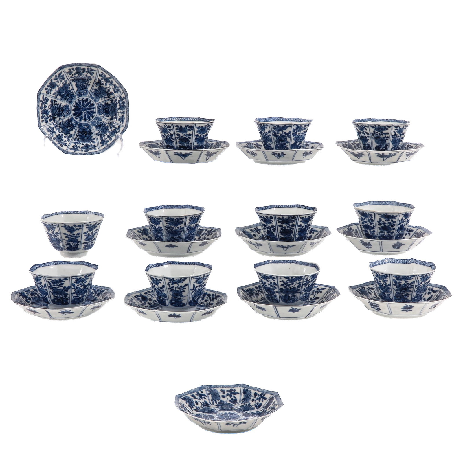 A Set of Blue and White Cups and Saucers: Octagonal shape, decorated with floral motifs, Kangxi Mark and Period, saucers are 13 cm. in diameter, chip and hairline.