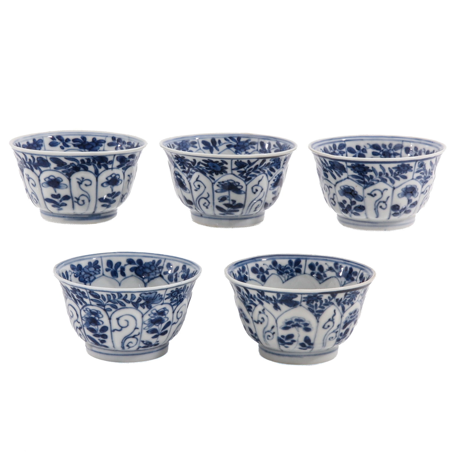 A Series of 5 Blue and White Cups: Decorated with floral motifs and paneled decoration, 18th Century, 7 cm. in diameter, hairline.