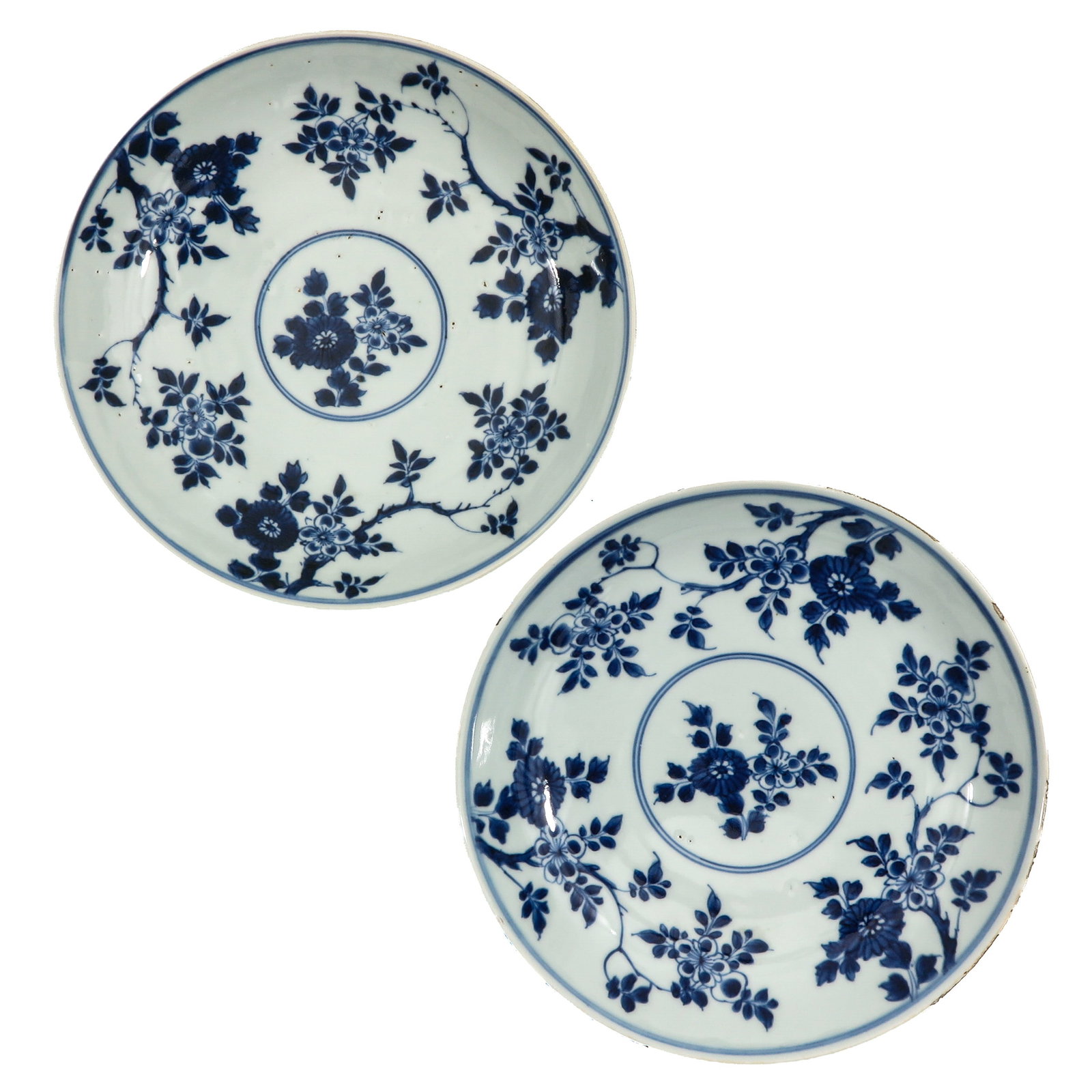 A Pair of Blue and White Plates: Floral decor, 18th Century, 22 cm. in diameter, chip.