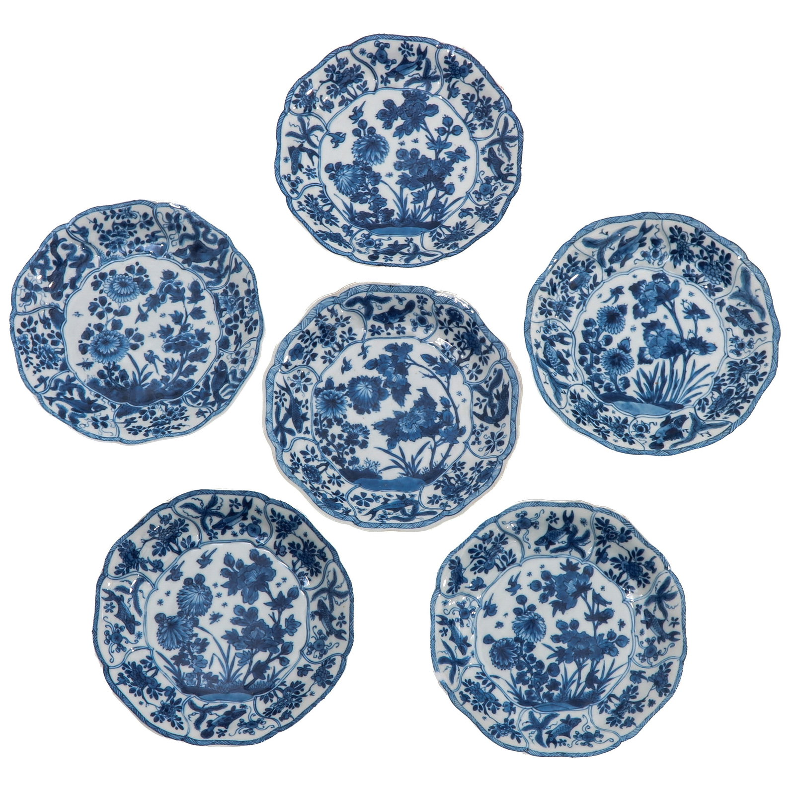 A Series of 6 Blue and White Plates: Decorated in underglaze blue with flowering plants and rockwork, Kangxi Period, 17 cm. in diameter, chip.