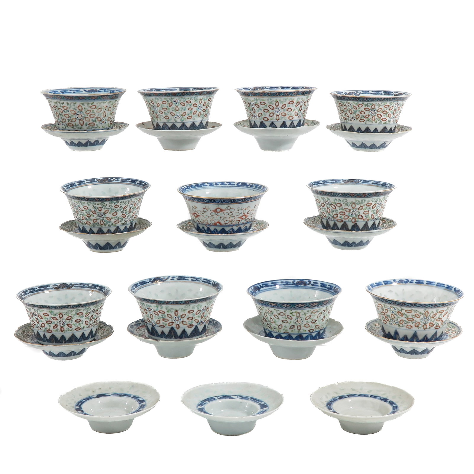 A Group of Cups and Saucers: Rice decor, decorated in underglaze blue, iron rred and green enamels, 19th Century, saucers are 13 cm. in diameter, chip and hairline.