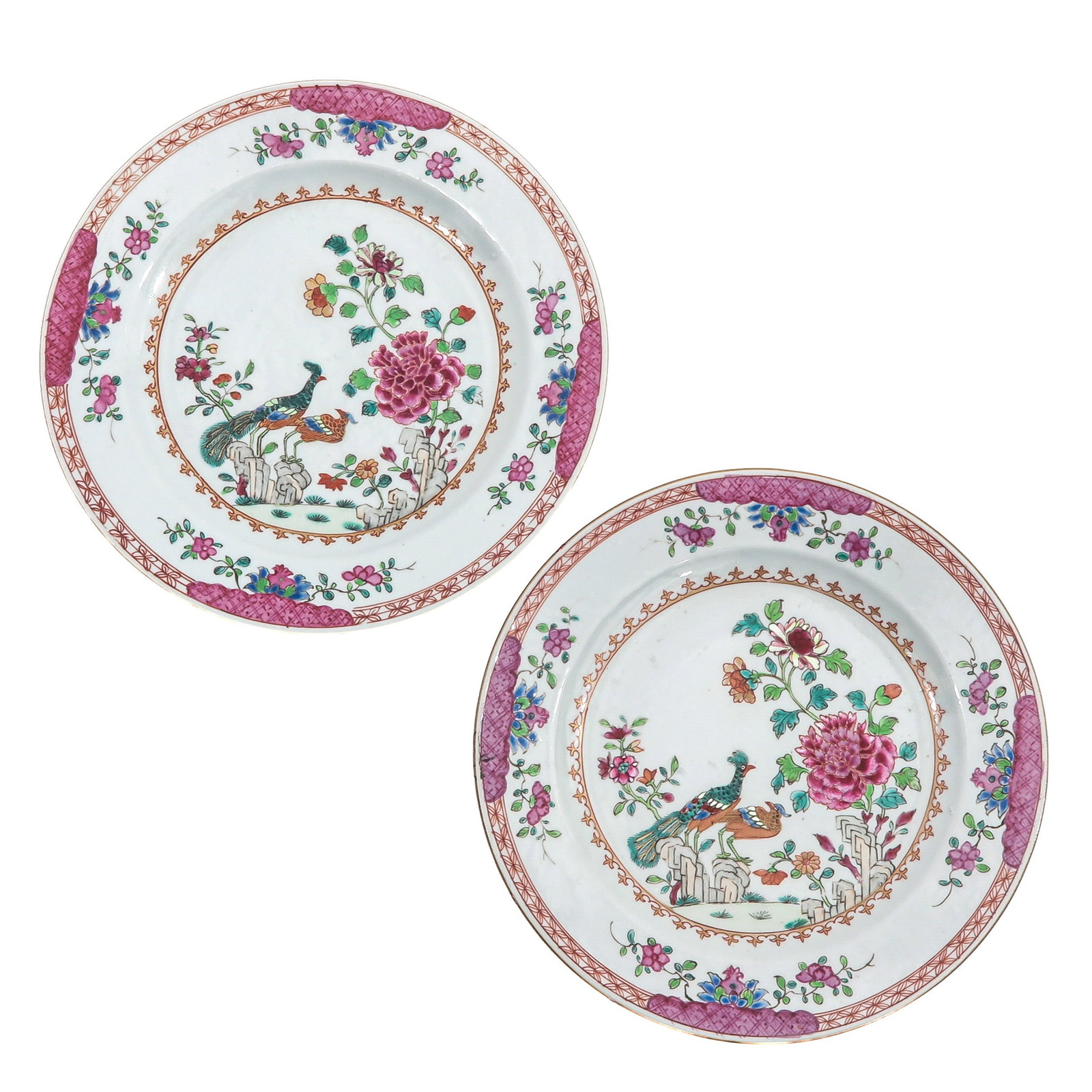 A Pair of Famille Rose Plates: Depicting peacocks in a garden, 24 cm. in diameter, chip and hairline.