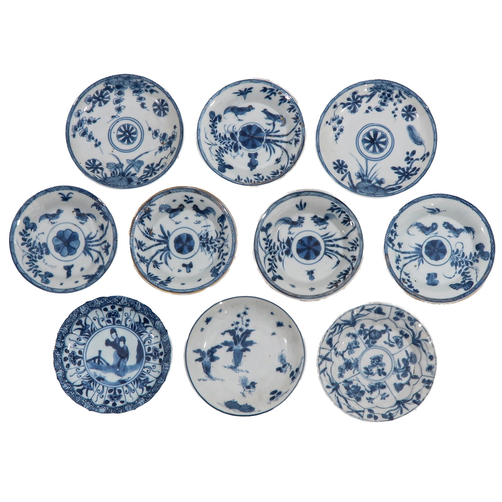 A Group of Blue and White Saucers: In a variety of blue and white decors, including 18th Century, largest saucer is 13 cm. in diameter, in diverse conditions.