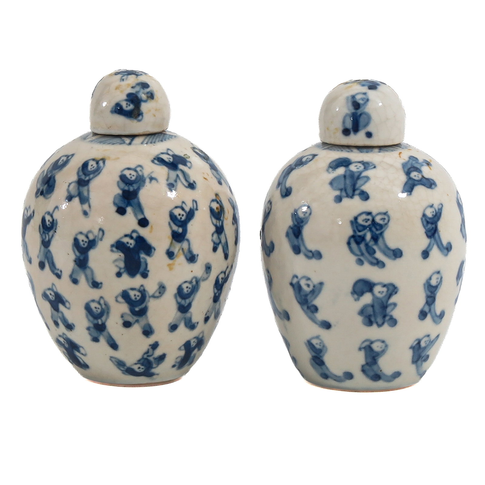 A Pair of Small Jars with Covers: Depicting Chinese boys, Kangxi mark, 8 cm. tall.
