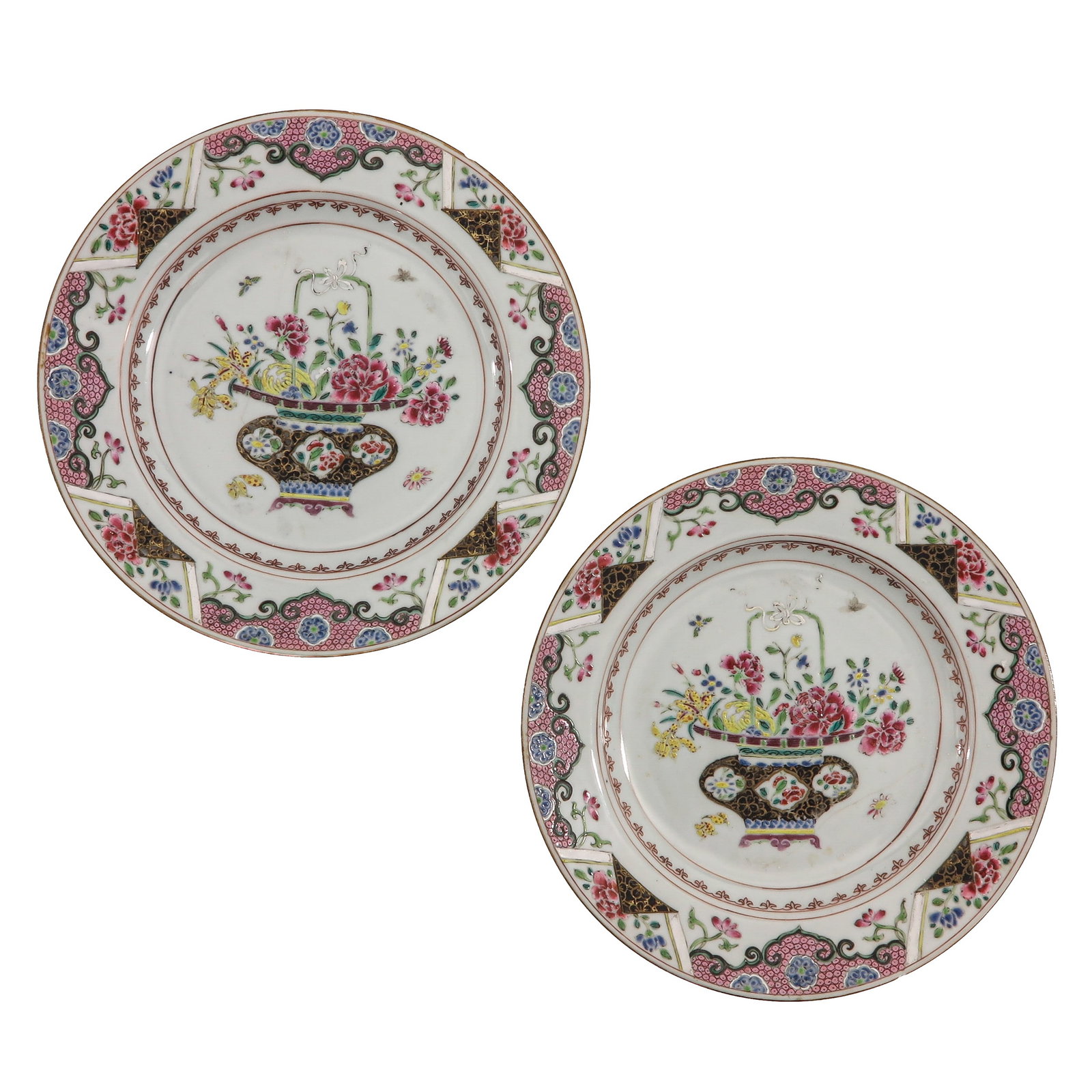 A Pair of Famille Rose Plates: Depicting a flower basket within a richly decorated floral border, 18th Century, 23 cm. in diameter, chip and hairline.
