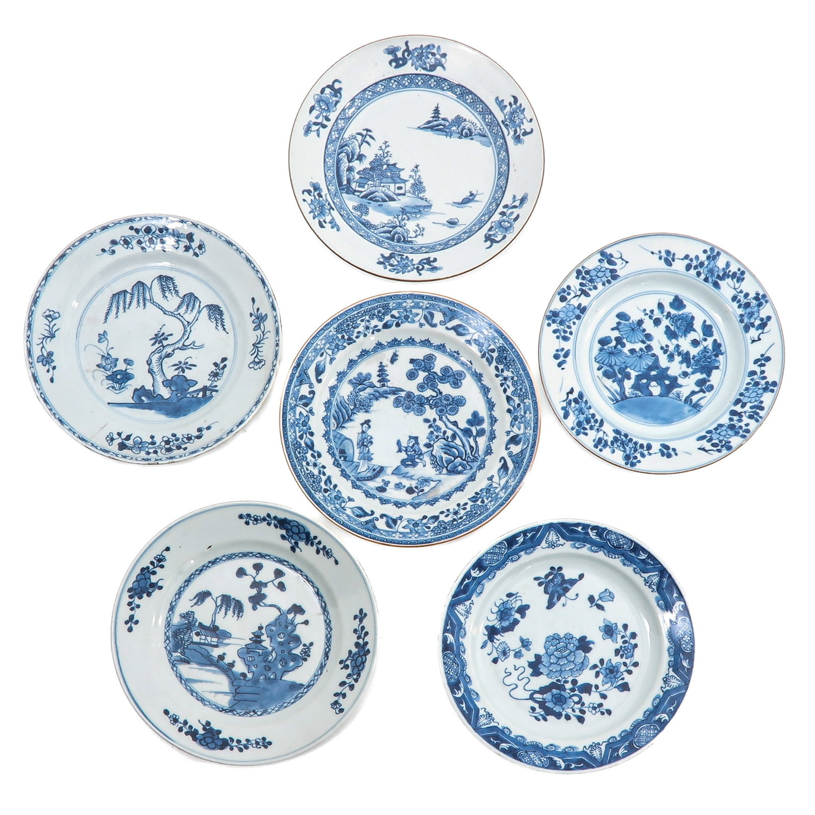 A Group of 6 Blue and White Plates: In a variety of blue and white decors, including 18th Century, 23 cm. in diameter, chip and hairline.