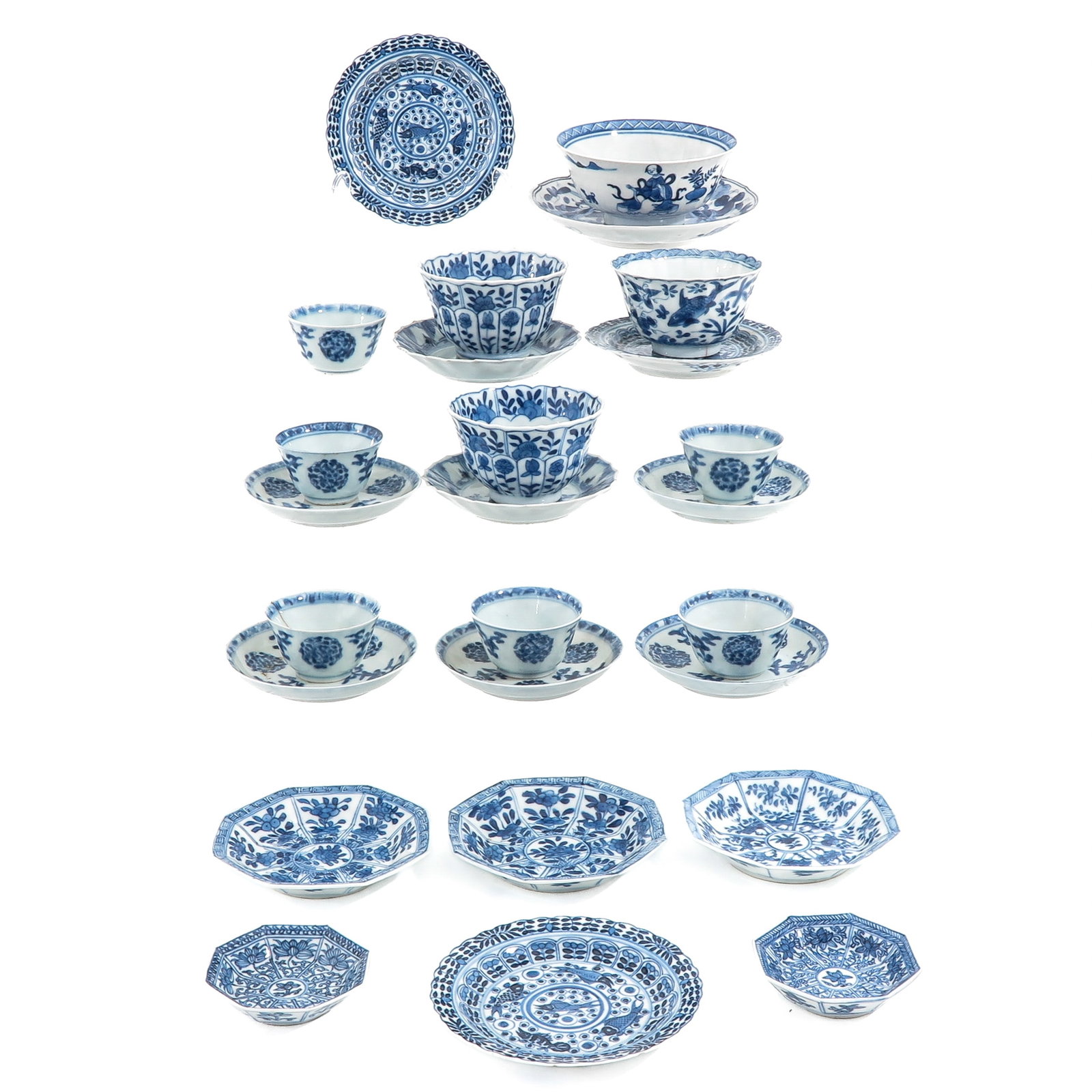 A Large Group of Cups and Saucers: 26 pieces, in a variety of blue and white decors, including 18th Century, largest saucer is 13 cm. in diameter, chip and hairline.