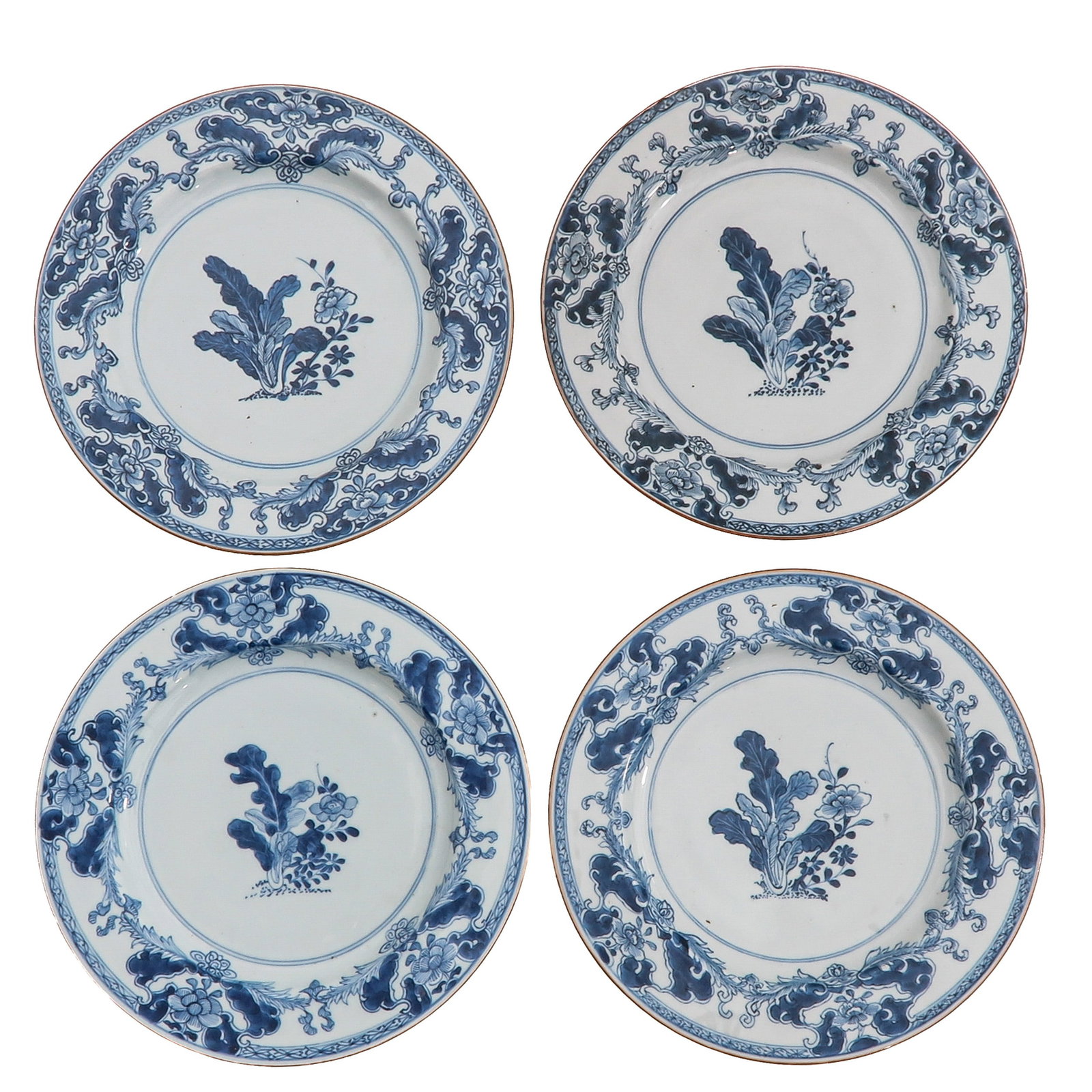 A Series of 4 Blue and White Plates: Each decorated with a central floral spray with tobacco leaves, within an ornate foliate border, 18th Century, 27 cm. in diameter, chip.