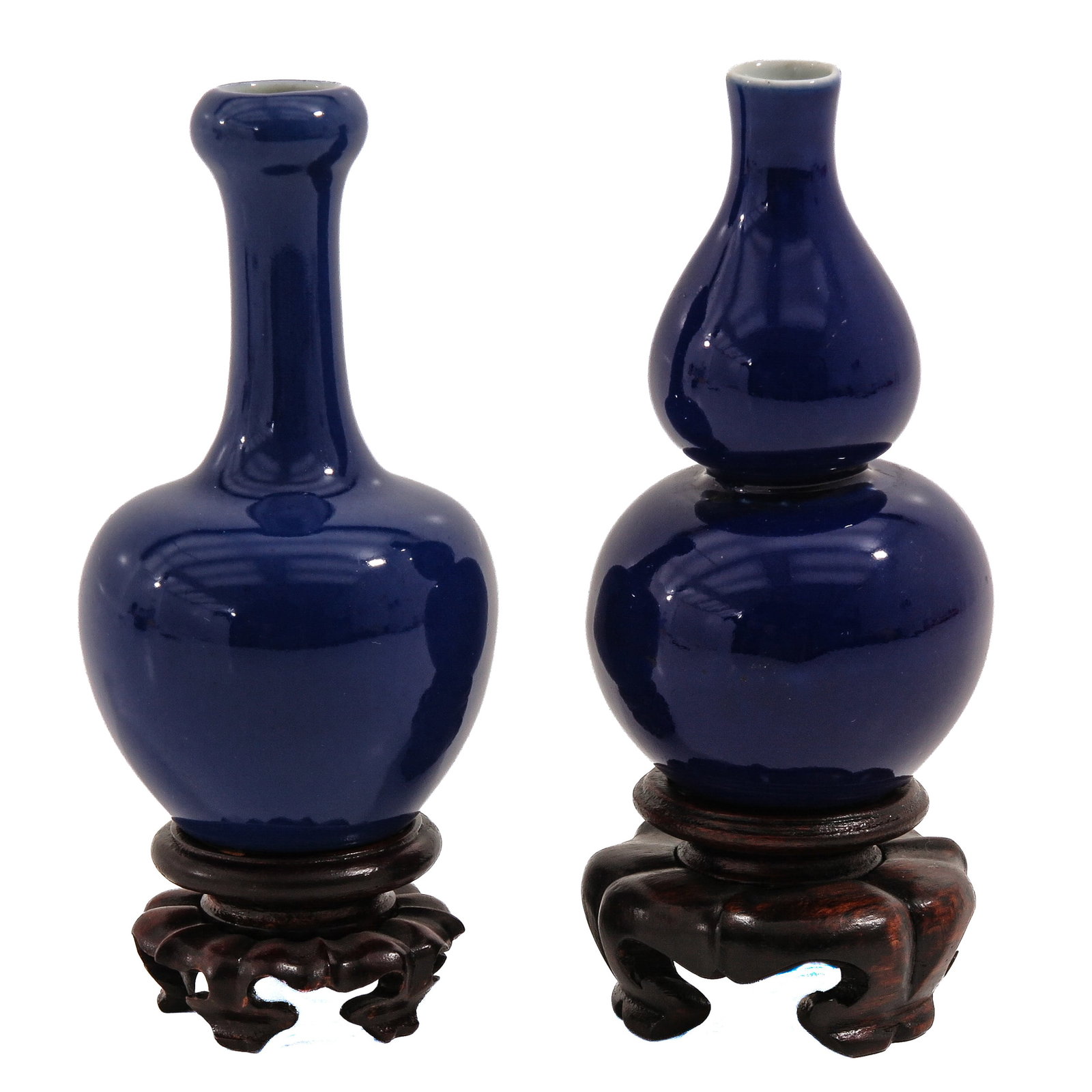 A Lot of 2 Monochrome Blue Glazed Vases: Including a double gourd and a garlic mouth vase, tallest is 11 cm., on carved wood bases.