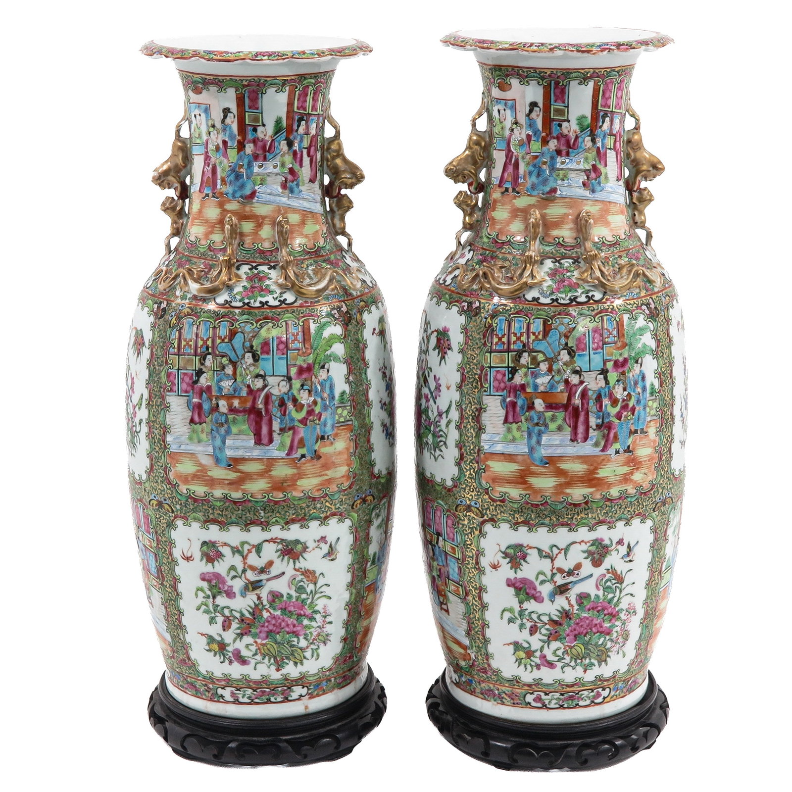 A Large Pair of Cantonese Baluster Vases: decorated with alternating figural court scenes and floral panels, applied with gilt temple lion handles and molded gilt decoration, on carved wooden stands, 62 cm. tall, with restoration on gilt deco