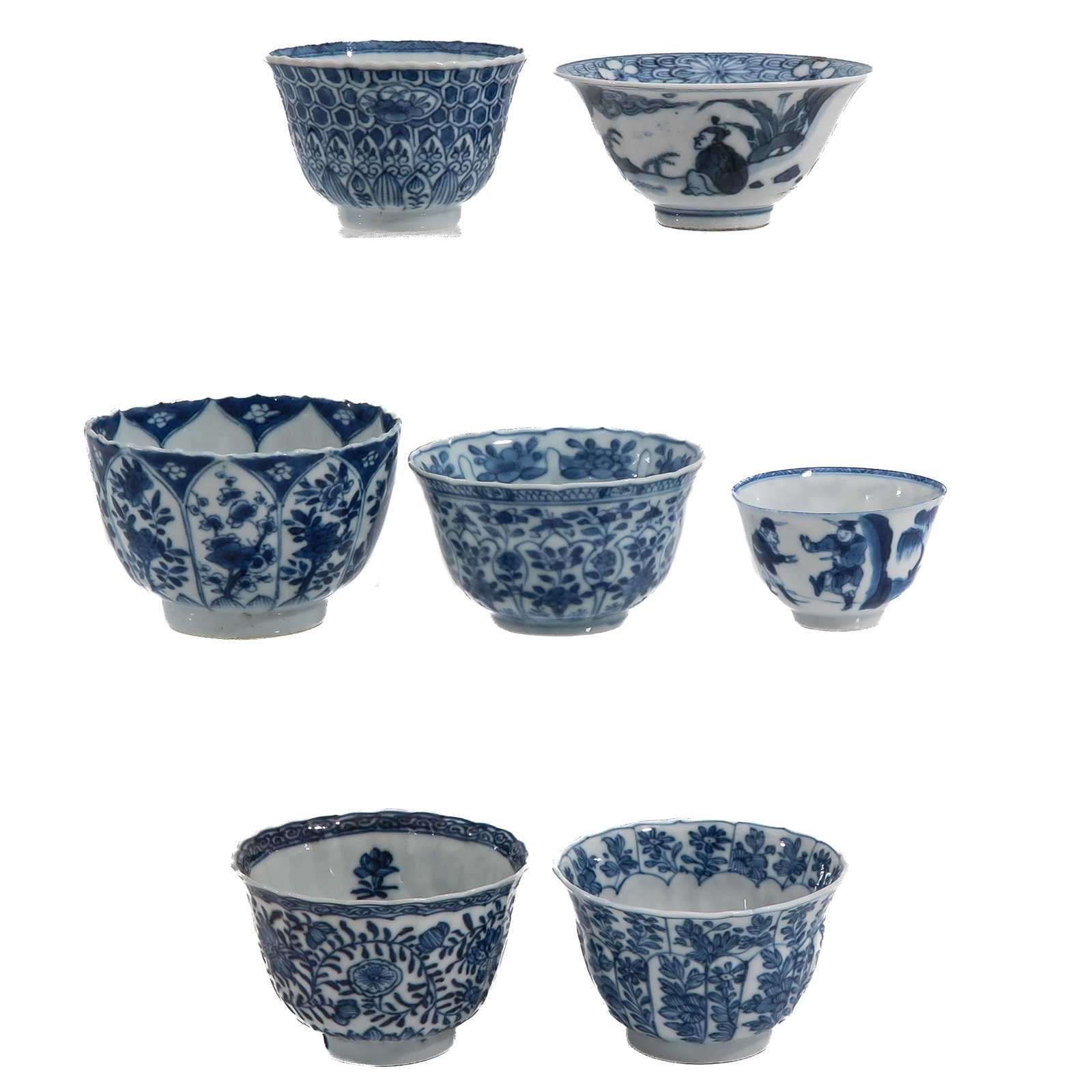 A Group of 7 Blue and White Cups: In a variety of decors, including 18th Century, largest cup is 10 cm. in diameter, hairline.