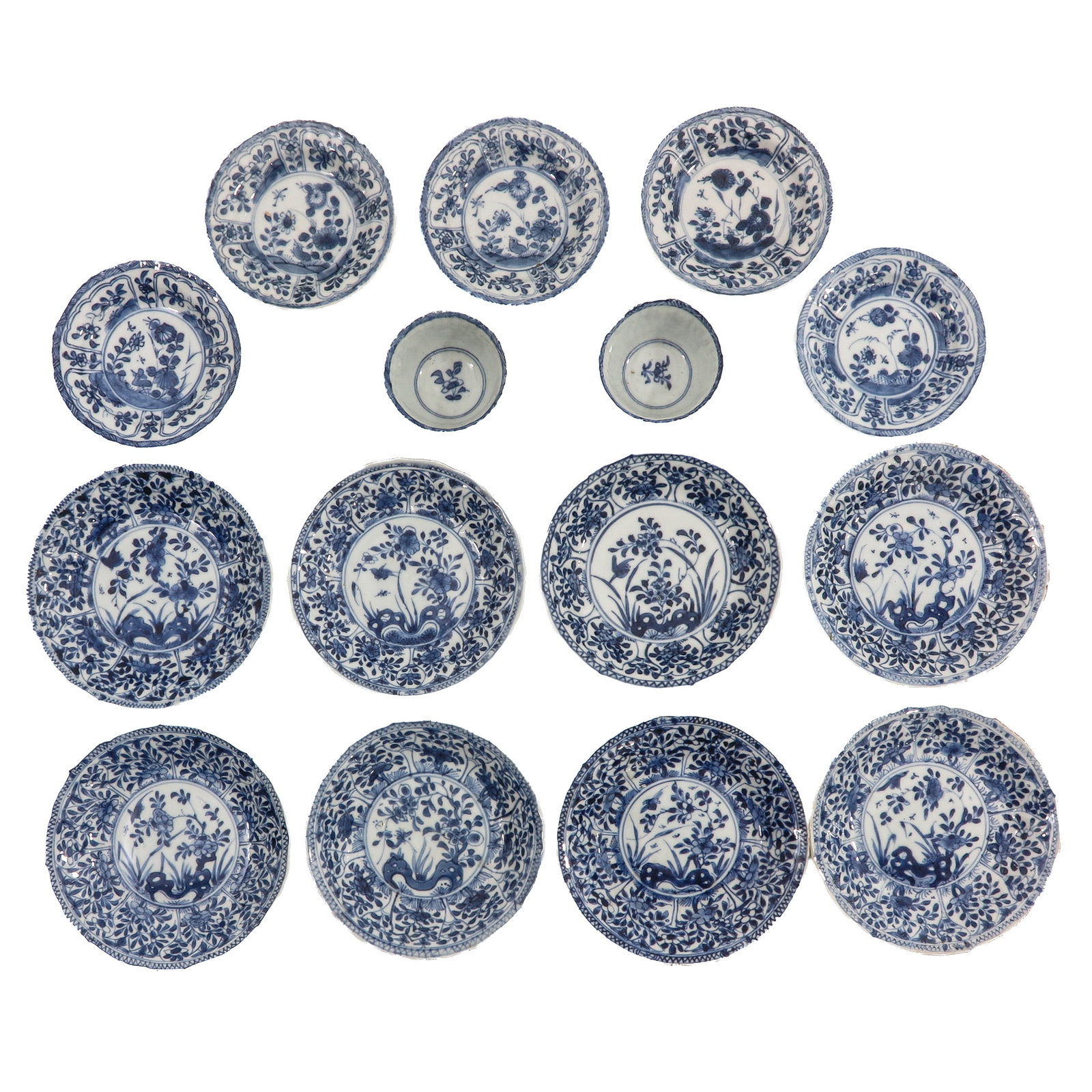 A Group of Cups and Saucers: In a variety of blue and white decors, including 18th Century, largest saucer is 14 cm. in diameter ,chip and hairline.